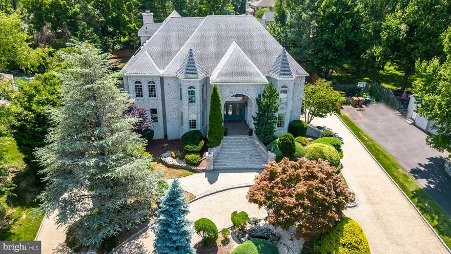 This palatial 5 Bedroom, 5.2 Bath home is located on one of the best streets in the highly sought after Holly Hill development in Upper Dublin Township. Award winning Upper Dublin School District with NEWER high school, brand NEW Sandy Run Middle School and desirable Jarrettown Elementary School. Just in time for Summer, a Heated Abana Free Form IN-GROUND POOL and oversized SPA will keep your friends and family entertained for years to come! This beautiful fenced in lot is nestled on over .50 acre with bordering mature trees.This majestic canvas has a light and bright inviting floor plan providing a once in a lifetime opportunity with endless possibilities to create a true masterpiece and is ideally situated for a multi-generational family. Distinguished details for this 7000 SF+ treasure (builders own residence home) includes a split 3 Car Garage with circular Belgian block driveway with dual driveway access; leading to the timeless brick step entryway met by oval panel French double doors inviting you into the grand 3 story Foyer floored in traditional marble and the grandeur of soaring ceilings. Additional details of this well appointed home features; vaulted ceilings with skylights and Palladium windows with flowing streams of natural lighting supported by recessed lighting throughout, comfortably efficient NEWER 4 zone HVAC systems, roof and gutters, 2 water heaters, 2 electrical panels, 3 gas Fireplaces, dual staircase and sprinkler system. The main level is flanked by both a formal Dining and Living Room with gleaming hardwood floors offset by a Game Room with wet bar, full sized Laundry Room, Large Powder Room, Home Office with egress to backyard/Patio, Bedroom with adjacent Full Bath that provides Outdoor Pool access; ideally set for an In-Law or Au-Pair Suite. The central 3 story Great Room features a floor to ceiling stone Fireplace, allowing access to your private paradise showcasing the manicured paved Patio and Pool. This sophisticated layout continues to the gourmet Kitchen, the perfect space and design for your holiday meal planning, featuring Wood-Mode cabinets, Corian counters, double sink with greenhouse window, Sub-Zero Refrigerator, double oven, large island with 5 burner gas cooktop, Breakfast Bar, Fireplace, walk-in pantry, butlers pantry and adjoining Breakfast Room with atrium doors and wall of windows that overlooks the Patio and Pool. The winding staircase to the 2nd level offers an impressive landing flowing to the Primary Bedroom, a private sanctuary with double door entry framed in beveled glass, opening to a spacious Loft, Sitting Room, Fireplace, 2 walk-in closets, dressing area, Balcony overlooking the private yard and massive marble Bathroom with oversized shower, huge Jacuzzi, bidet and Sauna. 4 additional spacious Bedrooms, each with its own Full Bathroom and double closets. The lower level with full egress, showcases a Mud Room flowed by a Finished Rec/Play Room, featuring a wet bar with granite countertop, Powder Room, Storage Room and Media-Theater Room with seating for six. The lower level invites you into a home with spectacular entertaining possibilities as well as extended living space for overnight guests. The backyard could accommodate a swing set, trampoline and/or a variety of sporting/hobby equipment. Set against the backdrop of an enviable location that offers a variety of lifestyle amenities; walk to the Promenade at Upper Dublin and enjoy your morning cup of coffee at Starbucks, shop at HomeGoods or pick up dinner at Sprouts Market. This fabulous property is situated in an amazing neighborhood where you can join in the annual yard sale, block parties and trick or treating events! With easy access to rtes 476, 63, 309, PA Turnpike, 2 Septa train stations, Mondauk and Aidenn Lair Parks, Esporta and Lifetime Fitness and historic downtown Ambler with its playhouse, movie theater and cafes. Your Dream Home is here! 1 year home warranty to the lucky Buyers!