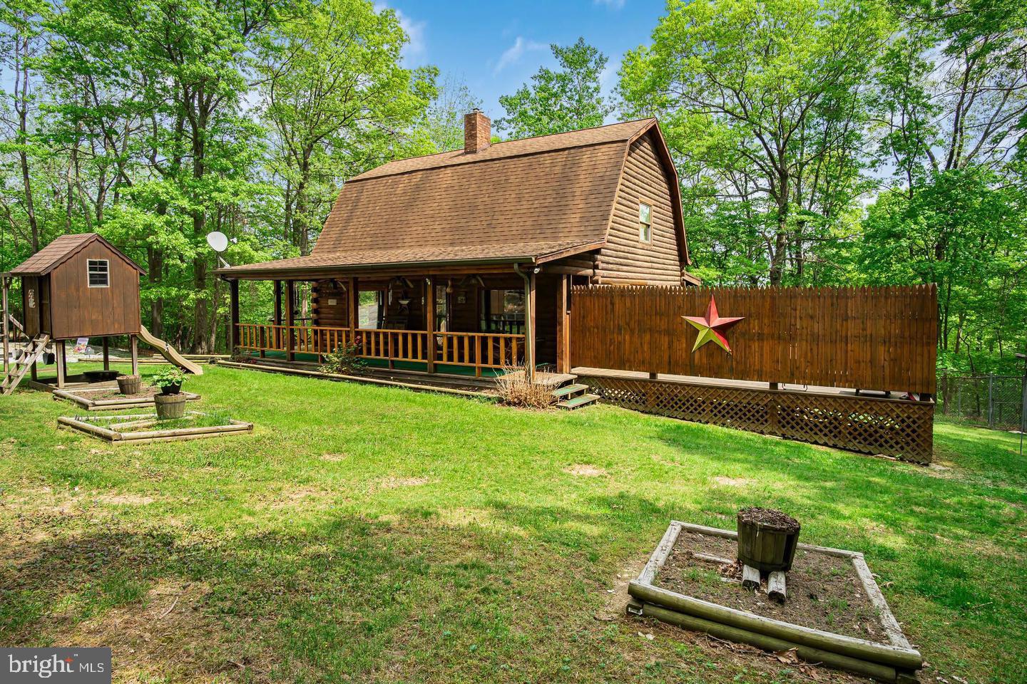 Welcome to 46 Woodview Rd, a captivating log cabin retreat that blends rustic charm with modern comforts. Nestled on a serene property, this home offers a covered front porch with a swing, and a relaxing hot tub/spa —perfect for unwinding in nature. Constructed with 8-inch thick log walls, this home boasts exceptional craftsmanship and timeless character. Inside, you'll find a warm and inviting atmosphere, highlighted by exquisite Black Forest pine floors imported from Italy (protected by carpet for preservation), real wood cabinetry, and a distinctive German-style barn roof. The charming kitchen features a striking brick wall with built-ins, adding character and functionality to the heart of the home. With 10 closets, storage is never an issue. The bonus room offers flexibility for an office, den, or even in-law quarters, while an additional space beneath the sunporch—currently used as a dog kennel—presents endless possibilities. The partially fenced backyard is ideal for pets, and the dedicated picnic area invites you to enjoy outdoor dining surrounded by nature. After a long day, retreat to your private hot tub/spa, where relaxation awaits. Conveniently located within an hour’s drive of Carlisle, Gettysburg, Hagerstown, Hanover, York, Chambersburg, Westminster, and Harrisburg, this property offers easy access to shopping, dining, historical landmarks, and employment centers. Outdoor enthusiasts will love being just 20 miles from Ski Liberty and only 10 minutes from Pine Grove Furnace State Park, where you can enjoy hiking along the Appalachian Trail, swimming and boating at Fuller and Laurel Lakes, and events like the annual Appalachian Trail Festival. Whether you're looking for a charming full-time residence, a vacation retreat, or an income-generating Airbnb, this property offers a unique opportunity to embrace log cabin living at its finest. 3 Bedrooms | 1.5 Baths | 3,000+ Finished Sq. Ft. | Partially Fenced Backyard | Bonus Room | Hot Tub/Spa—Schedule a showing today and experience the charm, comfort, and versatility of 46 Woodview Rd!