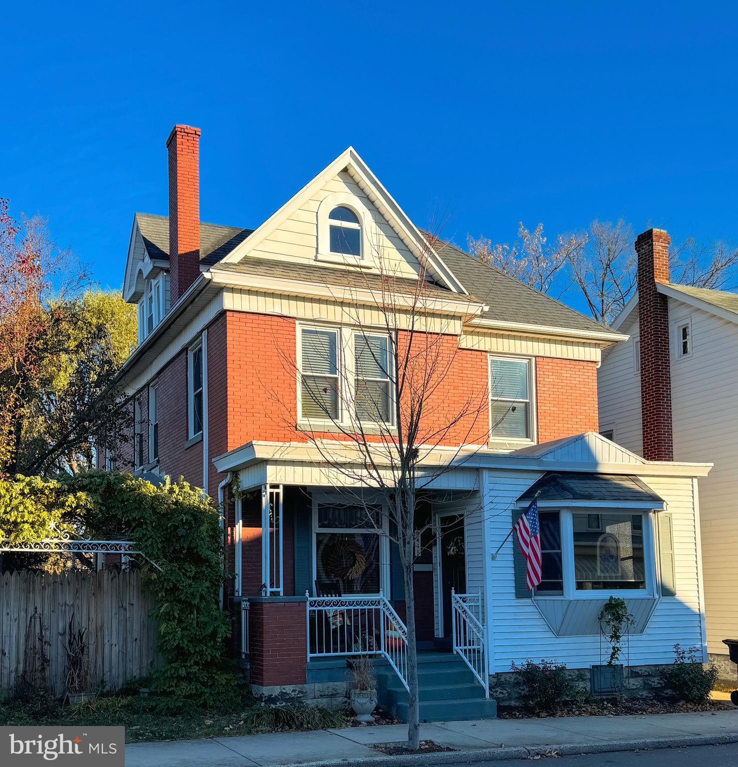 Enjoy small town living at it's finest in this 4 bedroom, 3 bath brick home located on a quiet side street in the heart of mid-town Huntingdon.  Enjoy the convenience of being  within close proximity to schools, the hospital, historic downtown, and restaurants. This older home is rich in character and charm as exemplified in the pristine original wood work, hardwood flooring and beautiful stained glass windows throughout.  Pride of ownership abounds in this well maintained home with modern amenities, energy efficient windows,  and a convenient layout while still  preserving  the unique features of an older home.   The minute you walk through the door, the feeling of "home" will embrace you.  Enjoy the benefits of a main level full bath, mud room, and enclosed back porch that brings the outdoors into a tranquil space to relax.  The front enclosed porch also offers a space to read, a music room, or just a space to get away from it all.  The second floor features a primary suite with large walk-in closet, 3/4 bath, and stack laundry, as well as two additional large bedrooms.  An additional full-size washer and dryer in the basement also convey with the home for those larger loads of laundry. The third floor offers additional living space with a large 4th bedroom featuring hardwood floors and a beautiful bay window with sitting area.  The enjoyment of home ownership and quality of life does not stop inside.  Step out to your private fenced back yard and embrace yourself in your very own outdoor oasis.  The brick patio with pergola, hot tub, garden, and room to play, as well as off-street parking round out the amenities of this one of a kind home.