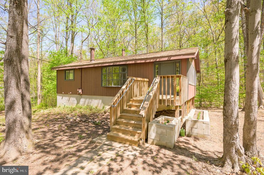 Multiple offers received.  Offer Deadline Wednesday, 5/14/25 at 5 P.M. Charming 3 BR, 2 BA Raised Rancher located in Glenwood Forest Subdivision with NO HOA! This affordable home sits on a 1.1 Acre lot offering a unique blend of nature and tranquility.  This property features Hardwood Floors, Kitchen Island, enclosed porch, family room with a cozy wood burning fireplace with beautiful stone surround, a wood stove in lower level adds added warmth and character with rooms awaiting your personal finishing touches. The home features a circular driveway offering plenty of parking and a shed in the backyard for your storage needs. Home inspection for informational purposes only. This home is being sold AS-IS. This gem is full of rustic charm with endless possibilities. Don’t miss out! Schedule your private tour today and let your imagine run wild.