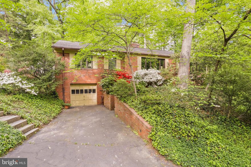 Opportunity knocks!   Value is in the land!   This home sits on a vast 0.56 acre lot and is sure to impress with its stunning beautiful deep flat lot with mature trees on over a half acre. Remodel or build your dream home in the desirable  and sought-after Bellevue Forrest neighborhood!  You will love your secluded yard in this well cared for brick rambler with a ton of charm in North Arlington! 
It presents a fantastic opportunity for you to make your own! Upon entering this raised rambler you will notice the spacious layout with plenty of natural light! The welcoming living room features a  gas burning fireplace and hardwood floors.  There is a bright sunroom surrounded by trees with lots of natural light, and access to the rear yard.   It is the perfect place to enjoy your mornings or watch nature from this "treehouse like setting".  Three bedrooms, 2 baths on main level. Fully finished lower level, large recreation room with wood burning fireplace. Basement has walk-up stairs to the backyard.    It offers a blank slate for landscaping or creating an outdoor space that perfectly fits your style. This house is full of potential and waiting for its' new owners to make it their own! Amazing location! Easy commute to downtown DC, Georgetown, Crystal City, Amazon HQ2, Reagan National Airport, and more!    `Bring your builders and contractors and design your dream home!  This house is full of potential and waiting for its' new owners to make it their own!