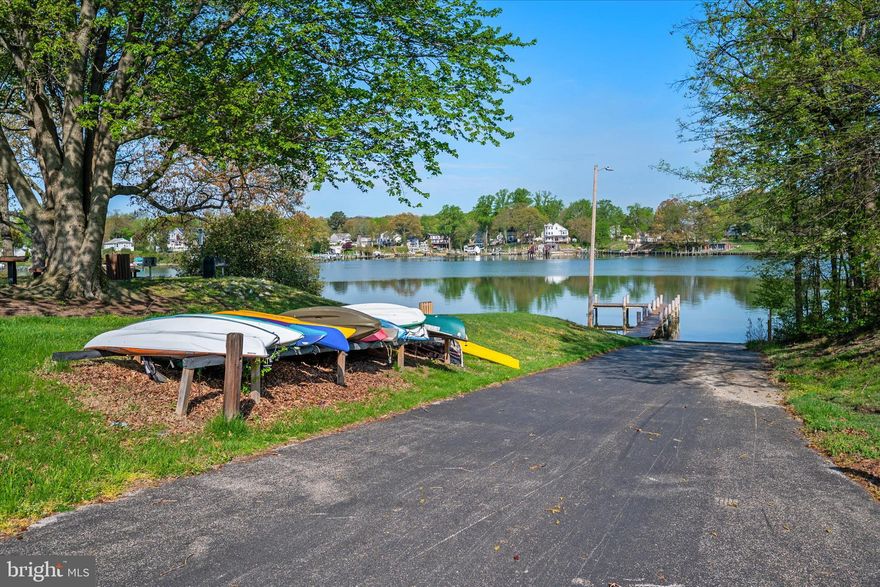 Welcome to 1195 Annis Squam Harbour—where waterfront community living becomes part of everyday life. Located in Elizabeth’s Landing, one of Pasadena’s most loved waterfront communities, this is the opportunity buyers wait for with private beach access, fishing pier, boat ramp, and scenic waterfront spaces along Stoney Creek just moments from your front door. Inside, the home immediately welcomes you with rich hardwood flooring throughout the entire main level and a layout designed for both comfortable daily living and easy entertaining. The sunlit living room flows seamlessly into a beautifully detailed dining area accented with chair rail and shadow box molding, while the kitchen offers 42” cabinetry, stainless steel appliances, designer countertops, classic tile backsplash, and direct access to a large deck overlooking the fully fenced backyard—perfect for entertaining, pets, or simply relaxing outdoors. The walk-out lower level adds exceptional flexibility with a spacious rec room, full bath with walk-in shower, and dedicated laundry area ideal for guests, additional living space, gym, or work-from-home setup. Upstairs, the primary suite features a walk-in closet and direct access to a dual vanity Jack-and-Jill bath, while two additional bedrooms provide comfortable space and versatility. This is more than a townhome—it is a chance to enjoy boating, beach days, waterfront sunsets, and the lifestyle that makes Elizabeth’s Landing so special, all while remaining convenient to Annapolis, Baltimore, and major commuter routes. Opportunities to get into this community at this price point are rare. Schedule your showing before it is gone.