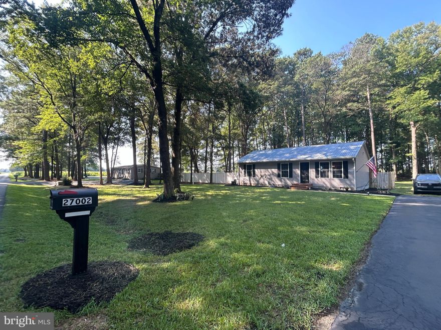 Are you looking for country living?  Experience peaceful country living on this beautifully renovated 1.49-acre property in rural Sussex County, DE. While the home has a Laurel mailing address, it's located in the Seaford School District and just minutes from Georgetown. With NO HOA, meaning no rules and no dues, you'll enjoy the freedom to make this space your own.  Let me say that again... No homeowners' rules AND No homeowners' dues to deal with!  That's a big deal!
The property underwent an extensive remodel in 2023 and 2024, to such an extent that it is now essentially, but not technically, a stick-built home on a permanent foundation. Inside, you'll find Luxury Vinyl Plank flooring throughout, wide baseboards, crown molding, and color-changing, dimmable LED recessed lights in every room. Soffit lighting on the exterior is also dimmable, adding a stylish evening glow.
The well-designed kitchen features Samsung SMART appliances—including the refrigerator, gas stove, built-in microwave, and dishwasher—all of which are smartphone programmable. Ample cabinetry provides exceptional storage within the compact, yet efficient, 960-square-foot floor plan.
The AC system includes a built-in humidifier, ensuring year-round comfort, and utility costs are impressively low; electric bills are generally under $100/month.
Outside, the spacious lot backs to a peaceful cornfield and boasts mature, healthy trees. There’s a concrete-floored shed with an overhead garage door, electricity, and water, perfect for hobbies, storage, or a workshop. Additional highlights include exterior motion lights, two backyard security cameras, and a cozy fire pit for entertaining under the stars. A standard septic system is in place.
This is a scarce find: a completely updated, energy-efficient home with modern features and ample room to roam in a quiet, no-restrictions country setting.  All this for a reduced price of $329,900.  This home has it all!