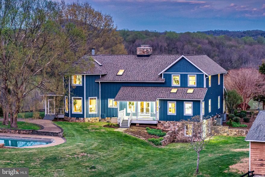 The impressive, custom timber‑framed home offers complete privacy and stunning views in every direction. With nearly 6,500 sq ft of living space, the main level features a dramatic great room with a floor‑to‑ceiling stone fireplace, an inviting living room, a sunken conservatory, a gourmet kitchen with Viking appliances and breakfast room, and a separate dining room with a second stone fireplace. A main‑level suite is also possible.
The upper level includes a spacious primary suite with a wood‑burning fireplace and expansive views, a loft/office area, and two additional bedrooms. Floors were fully refinished in 2026, showcasing a beautiful blend of pine, cherry, and oak throughout. Fresh interior paint (2026) and new fans and light fixtures throughout add a clean, updated feel. The lower level offers a separate entrance, media room, and generous storage.
The grounds are equally captivating, with a pool and waterfall, multiple porches, gardens, and a charming pavilion with firepit. The pool has been thoughtfully maintained with a new heater (2021), new pump (2023), and a new cover (2025). A separate 5‑car garage provides large doors, a lift, and a shop area. Fenced fields and a 4‑bay machine shed create an ideal opportunity for a small farm or simply enjoying complete serenity.
Recent improvements include two new HVAC units (2024), a new roof in 2022, new Hardie Plank siding in 2023, new water heater (2024)and additional updates available upon request. Starlink internet is installed. Seller is not responsible for roll‑back taxes.