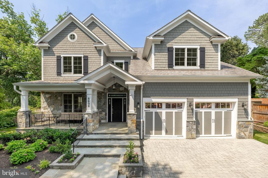 A jewel in the heart of Bethesda, 5606 Parkston Road is a masterfully crafted residence situated on a peaceful, tree-lined street in the highly coveted Springfield community. Prominently sited on a lush, tranquil block, the home’s stately exterior begins with a paver driveway and a rising flagstone walkway leading to a dramatic gabled portico and broad covered front porch, an inviting introduction to the spacious, over 7,500 square feet of luxury within.
Originally constructed by award-winning local builder Tulacro Development, this home reflects timeless craftsmanship enhanced by thoughtful updates tailored to modern living. A rebuilt grand staircase anchors the open-concept floor plan beyond a welcoming vestibule, setting the tone for a residence where scale meets sophistication.
Ten-foot ceilings, light-stained oak flooring, and layered crown moldings define the main level, imbuing the interiors with warmth and expansiveness. A formal living room, complete with a gas fireplace framed in stone, flows seamlessly into the large dining room, where a trio of windows overlooks the side yard. A grand chandelier centers the space, and a butler’s pantry connects it to the chef’s kitchen.
At the heart of the home, the kitchen is a dream for entertaining and everyday living alike. Luxurious countertops wrap around a substantial center island, complemented by full-height stacked cabinetry with glass displays. A state-of-the-art Thermador appliance suite includes a commercial-grade range and high-capacity hood, built-in refrigerator, and twin dishwashers. The adjacent breakfast area overlooks the rear lawn, while quadruple-hinged French doors blur the lines between indoor and outdoor living, opening the family room to a flagstone terrace. Anchored by a floor-to-ceiling fieldstone fireplace, the family room is both spacious and inviting.
A set of French doors leads to a versatile main-level den, perfect for use as a private office, library, or bedroom, offering multigenerational flexibility.
Upstairs, the primary suite offers a private, peaceful retreat with wooded views. The spa-inspired bath features limestone flooring in a Versailles pattern, detailed tilework, a jetted soaking tub, double granite vanity, walk-in glass shower, and separate water closet. A generous walk-in closet completes the suite. Three additional en-suite bedrooms and a convenient laundry room round out the upper level.
The top level offers two more bedrooms with a shared full bath, ideal for a playroom, yoga studio, or au pair suite.
The fully finished lower level is designed for entertaining on a grand scale. A spacious recreation room features yet another floor-to-ceiling fieldstone fireplace and walk-out access. A dedicated home theater, fitness room, additional bedroom, and full bath make this level as functional as it is fun. An integrated surround sound system extends throughout the home and into the outdoor areas.
High-end mechanical upgrades include a DaVinci roof, tankless water heater, and backup generator, ensuring peace of mind and long-term efficiency. The private, fenced backyard is an oasis unto itself, with manicured landscaping, a flagstone patio, and premium turf offering low-maintenance enjoyment for lounging, dining, or entertaining al fresco.
Set within steps of local parks and scenic trails, and just across River Road from the prestigious Kenwood Country Cluband Woodacres' renowned cherry blossom display, the home is also just minutes to the reimagined Westbard Square, Downtown Bethesda, and major commuter routes. Belonging to top-rated public and private schools, this location truly checks every box.