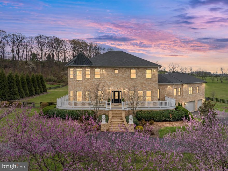 Perched on 2.75 private acres with panoramic valley and mountain views, this extraordinary estate is a true showpiece among Winchester’s finest homes. With over 6,000 finished square feet, a fully fenced backyard adorned with cherry and magnolia trees, and unforgettable outdoor spaces that match the inside of this one-of-kind home,  this is luxury living redefined—graceful, timeless, and effortlessly welcoming. From the moment you arrive via the sweeping half-circle paved driveway, you’ll feel the elevated elegance that defines this residence. Wrap-around no maintenance decks, a flat backyard with a fire pit, and a covered stone patio invite year-round entertaining and quiet moments alike—all framed by 365-degree views that capture the beauty of every season. Step inside to soaring ceilings, double crown molding, curved walls, exquisite hand painted wall coverings and surprising details throughout. Unique wood floors, salvaged from a Chinese monastery, add warmth and character, while every bathroom in the home is finished in marble—luxury in every corner. The layout is both grand and inviting, with expansive, light-filled rooms from floor to ceiling windows, designed for both impressive entertaining and comfortable living. The main level features a breathtaking primary suite wing, complete with a generous sitting area, walk-in closet, and spa-like bath with an infinity tub and custom stained glass window. Upstairs, a dramatic curved staircase leads to a spacious central gathering hall and large bedrooms—each with an en suite bath and captivating views from every window. The fully finished lower level offers an additional bedroom, a massive recreation room with oversized windows, and double cinder block construction for peace and durability. Unfinished spaces provide abundant storage or the opportunity to expand. Notable updates include a brand-new roof (April 2025), re-pointed stonework and new backyard patio (2023), and newer HVAC and water heater (2021), among the many others. Best of all, it sits just 10 minutes from Winchester Medical Center and 15 minutes to the heart of downtown. This is truly a rare opportunity to own a home that is as refined as it is welcoming. Grand in scale, yet grounded in comfort—this property makes for an extraordinary setting for celebrating life’s most memorable moments.