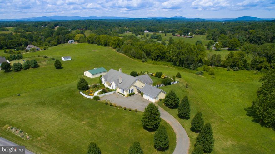 Rare light-filled custom ranch on bucolic 10 acre setting just minutes from Warrenton. Gorgeous mountain views from family room and large deck. Open one level floor plan featuring gourmet kitchen w/ 15 foot center island, top appliances , dining room with fireplace, sun room, 3 fireplaces, 3 bedrooms, 3.5 baths. New carpet, Large 2 car garage w/ covered breezeway, large 46 by 36 barn.Full Basement