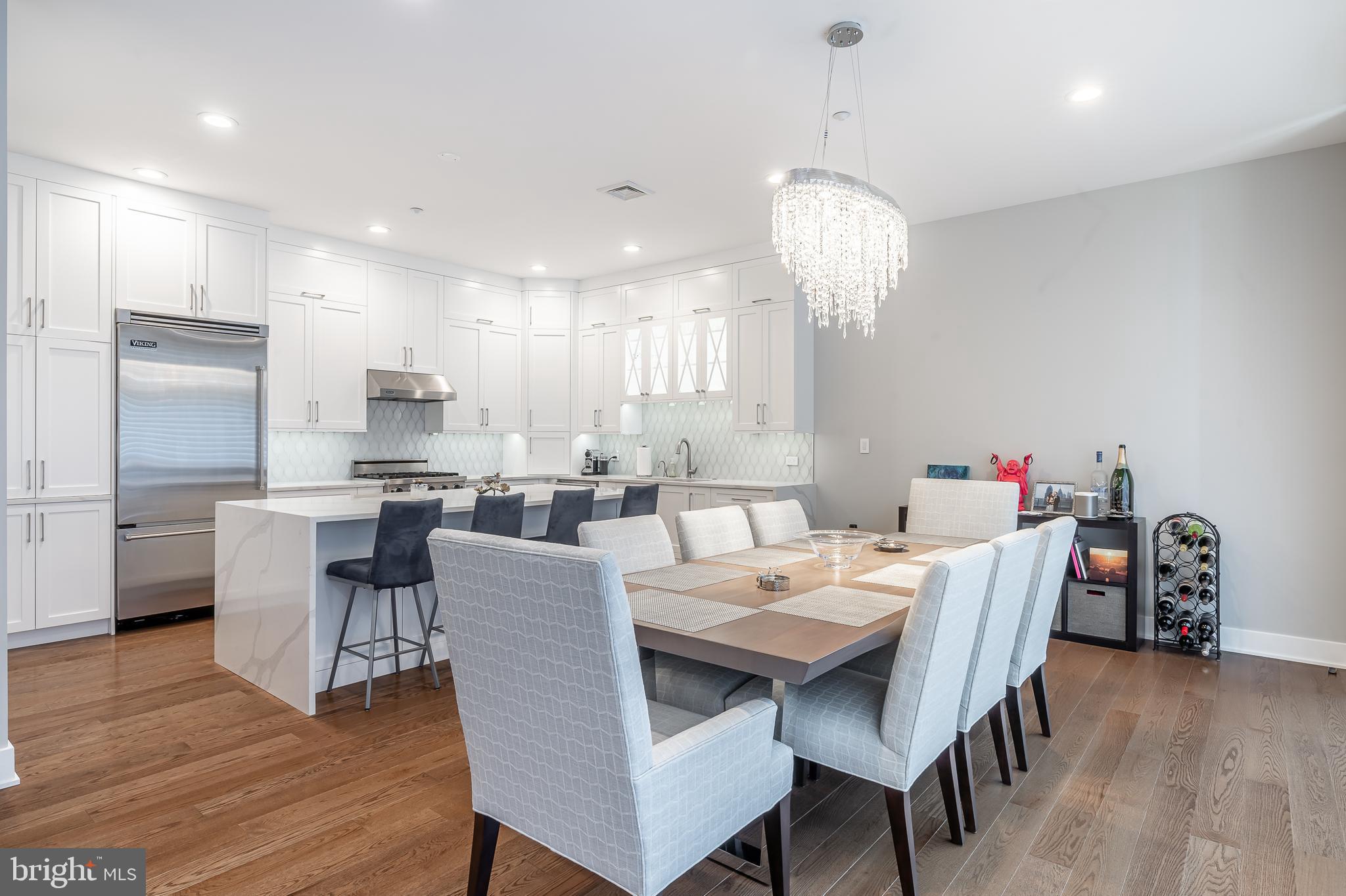 A TRULY TURN KEY 2 STORY PENTHOUSE! This home has been fully renovated with no expenses spared on this recently completed Penthouse re-design. This Bi-level Penthouse is just shy of 3,000 sqft with 3 bedrooms PLUS a Den/Office, 2.5 bathrooms, 350ft west river-facing deck, along with an additional 2 balconies on the 2nd level. As you open the double doors and set foot into your entrance you are flooded with daylight from floor to ceiling windows. Immediately your eye is drawn to the stunning wide-open, 50 foot long entertainment and kitchen area with a Gourmet Chef's kitchen and 8 foot island. The kitchen is complete with a Viking kitchen appliance package, Cambria Quartz surfaces with gorgeous waterfall sides, Kohler touchless faucet, filtered main and instant hot water, in and under cabinet lighting, gorgeous crystal chandeliers, and fully custom designed, hand-made solid wood cabinetry. The unit features Mirage wide-plank, engineered wood floors throughout which were leveled and set over a high-end cork subfloor to dampen sound. Other home features include Lutron controlled lighting and programmable switches, including over 50 recessed lights, Nest thermostats, and Lutron and HD Silhouette blinds along with an Amanti electric fireplace. EVERYTHING is wireless in this state of the art penthouse. The stairs feature modern wrought iron railings that will lead you to the 2nd floor with 3 bedrooms and 2 baths. The MASSIVE Master Suite has soaring 16ft ceilings, huge windows and lighting galore, or with a touch of your finger on your app or remote the blackout shades will quietly close. The Master Suite includes a fully custom, wrap-around, walk-in closet that has enough space to be another bedroom and features hand-made solid wood cabinetry. The Master Bath will blow you away with its oversized tub and shower large enough to fit two! Cambria quartz on the multiple surfaces and waterfalls, along with Hansgrohe and Graff fixtures, heated tile floors, separate toilet room with storage, and a 9 foot dual sink vanity with makeup counter and tons of storage. The two other bedrooms and bathrooms have high-end finishes as well and plenty of closet space. Hall linen closet next to a second floor laundry room with brand new Samsung washer and dryer included. First floor office and powder room. Unit includes 4'x6'x9' lockoff storage located on building lower level. There is storage everywhere in this luxury penthouse redesigned from top to bottom with no detail forgotten. You are a few blocks away from Rittenhouse Square, restaurants, and shopping everywhere, and the Schuylkill River Trail is a block away. 30th street station is a 5 minute walk with quick access to NYC-DC Amtrak. It is truly rare to come across a property that has everything including a very desirable outdoor space and is only a couple of blocks away from Albert Greenfield elementary school - Blue Ribbon winner! Owners will include 1 year of pre-paid garage parking located inside the building.