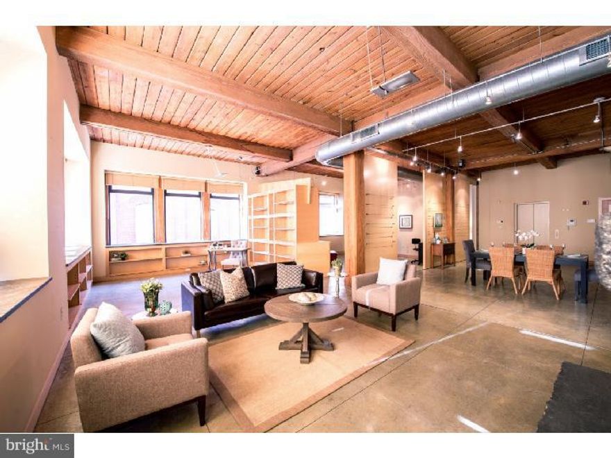 Truly one of the City's great spaces. This home is an upscale contemporary with original 19th century loft character, designed for living in the 21st Century. Its unexpected spatial generosity and contrasting interior materials combine to make a remarkable setting for living, working and entertaining. 2-4 bedroom, 2 bath full floor loft residence in a historic, boutique condominium building. 11.5' ceilings, spectacular character, and fine finishes on a serene, tree-lined Old City Block. 1-car, gated on-site PARKING. The secure elevator opens directly and dramatically into this 3,755 square foot home, which includes the entire light-filled 2nd Floor of this old factory (c. 1895). Designed by renowned architect, Jorge Lovera, this space offers 2 full bedrooms; a guest room/office/studio (that could easily be a large, delineated bedroom); and another large office/den that could readily be turned into a 4th spacious bedroom. A private balcony. 6.5' high windows on 3 exposures. Charming views. And living space that is so pliable it works for huge open entertainment; or as more intimate (yet roomy) spaces, easily crafted into separate areas for a living room, sitting room, family room, office and dining room. And all this opens to a custom kitchen, with poured concrete counter-tops, sink and eating bar, plus a breakfast area. Enjoy the purposeful contrasts of materials, from the radiantly-heated concrete floors to the original wood ceiling with 120 year old beams & cast iron connection supports; the fireplace that contrasts heavy steel plates (designed & crafted in Italy) with sandstone & rough granite; 2" thick & deep slate windowsills; custom maple & sycamore cabinetry, shelving, and 11' sliding doors; exposed brick, ductwork, and beams (wood & iron); the unexpected pair of antique hand-carved wooden doors. The quality & scope of the materials is just seductive. Wonderful art exhibition space; however, the intrinsic quality of the home is rich enough to support itself elegantly, with little art at all. At either end of the spectrum or anywhere in between--it just works. Excellent storage. High-end finishes. Superb location, at the most quiet intersection of cobblestoned Mascher & Cuthbert Streets, yet within blocks of so many great restaurants, coffee shops, & the Ritz Movie Theaters. 97 Walkscore. Notes: 2-zone AC. 2-zone radiant heat concrete floors. Efficient & comfortable. Professionally managed, pet friendly building. Great closets. Oversize laundry room.