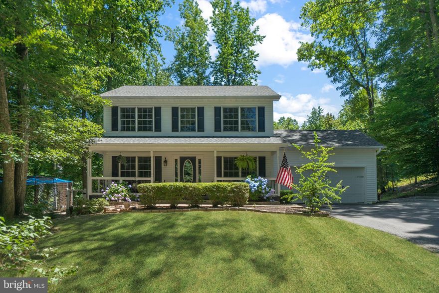Swoop in on this charming  home located in North Stafford near Widewater. Situated on nearly 2 private acres of land it's out of town but close enough to shopping, dining & commuting to points north. Pour the sweet tea.. The covered front porch is ready for your rocking chairs and hanging ferns. The traditional center-hall floor plan hosts both formal dining and living rooms, a double sided fire place and a country kitchen with plenty or storage and counter space. The cheerful kitchen has stainless appliances, maple cabinets, a secretary's nook and  access to the breezy deck- perfect for grilling and dining. Hardwood flooring covers the main level while plush carpet fills in all  the right places upstairs and downstairs. The lower level has a rec room, full bathroom and two additional bedrooms (NTC) Plus walk out access to a patio. The entire property has been thoughtfully improved and cared for with a 30 year architectural shingled roof, newer HVAC inside and out, newer water heater, newer water pressure tank and water treatment system. The lot is surrounded by thick wood line and is planted with mature fruit trees, grapes on the vine and a raised garden.   The outbuilding could be set up as a barn & tack room or used for storage. Close proximity to Widewater State Park and Potomac Point Winery. Living is easy on Raspberry Lane!