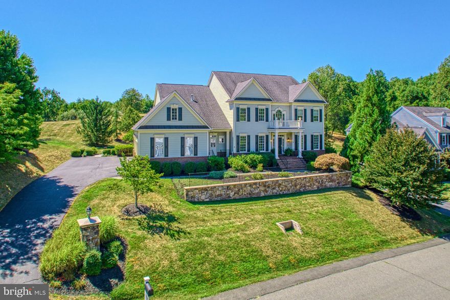 A charmer of soft-hues, stone detailing, and nearly an acre of tree-dotted grounds, this lovely Beacon Hill Colonial welcomes as 7,036 square feet captivate with chic sophistication and modern trimmings. Within your open floor plan of both casual and formal living, guests are welcomed with handsome Cherry floors, swoon-worthy checkerboard stone, effortless millwork, view-filled windows, and conversation-warming gas fireplaces. Host film screenings in the home theater, pour drinks during game nights at the lower level bar, and be inspired by your elegant kitchen where professional-grade appliances, butler’s pantry, place for business, and breathtaking ambiance provides a haven for displaying bites at the island while entertaining in the sunlit living room. While the window-lined office provides fireplace-warmth for work, you’ll dine al fresco on the stone-lined patio overlooking your expansive yard. Here, host birthday celebrations, enjoy sunrise strolls to the walking trail, and consider plans for the pool or garden of your dreams. Thoughtfully constructed for every-day life, a petite mudroom, built-ins, and gorgeous modern lighting provides comfort, while four oversized retreats for rest are each complemented by en
suite baths. In the primary, unwind within your sitting nook, dress within dual walk-in closets, and let your
oversized bath invite you to unwind. While on tour, visit the lower level’s bonus room for overnight guests, and imagine tuning your collectable vehicles in the three car garage outfitted with lift bay, high-end cabinetry, and custom flooring. Tucked into a desirable location of Beacon Hill where nearness to neighbors provides a sense of community, you’ll enjoy signature wide open spaces, with proximity to wineries, historic Leesburg, scenic parks, commuter routes, and more within picturesque Loudoun County.