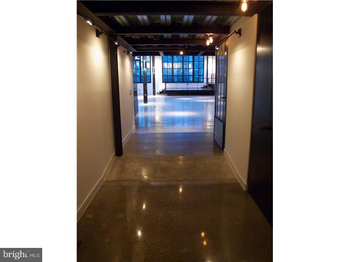 Stunning, top floor, 5100 square foot luxury loft overlooking the Reading Viaduct. Your own freight elevator opens directly to loft and to a heated garage with your 3 deeded parking spaces consisting of 1 space next to 2 tandem spaces. With 8000 lbs. of capacity, your own elevator allows you to take your groceries, your bike or even your motorcycle right into the loft! The main level features a wide-open floor plan with 24-foot ceilings and skylights, massive south and west facing windows with city views, a balcony with operable window doors, storage/workshop area, theatre/media room, den, full bathroom featuring Waterworks fixtures and an extraordinary chef's kitchen. The scene-stealing, 20-foot soapstone island provides front row seating for your guests as you cook on top-of-the-line appliances including: 2 Waterworks farmhouse sinks & fixtures, 2 Bosch dishwashers, a 48" Sub-Zero Pro refrigerator with glass door, a 48" Wolf dual fuel cooking range, custom mahogany cabinets and a custom, walk-in glass wine closet. At the touch of a button, Lutron control systems operate the shades and lights. Museum quality track lighting, along with vintage and antique lighting, are featured throughout the loft. Two spacious en-suite bedrooms with large, bright bathrooms featuring Waterworks "rain" showers and Waterworks freestanding cast iron bathtubs. Other features include radiant floor heating on main level and all bathrooms, polished concrete floors on main level, ebonized wood floors on upper level, a 26-foot Sapele wood bench made out of one piece of wood, video surveillance, fingerprint locks and a double storage unit in the common hallway on same level. Originally two units, this labor of love was painstakingly renovated and converted into a one-of-a-kind residence. All custom steel, including grand staircase, created by local artist, Bill Curran Designs. Close to the subway and convenient to many attractions of the city!