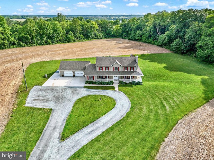 Welcome to your private country oasis! This beautifully maintained 5-bedroom, 3 full and 2 half-bath home is situated on 20 picturesque acres with the option to purchase an additional 10-acre parcel (additional acreage is NOT available separately). Mature trees and thoughtful landscaping create a peaceful setting, while a pond with a fountain adds to the charm. Inside, the open floor plan features a spacious eat-in kitchen with an island, a main-level primary suite with laundry, and a second laundry area upstairs for added convenience. The partially finished basement includes a unique work room with underground vault access. Energy efficiency is a priority with a geothermal heating system and multiple hot water tanks. Enjoy outdoor living with an outdoor playset, wraparound porch, and ample yard space. The oversized 2-car garage offers extra storage and workshop potential. This property is a rare blend of comfort, function, and rural beauty—perfect for those seeking space and serenity.  Showings will start June 4th with an Open House scheduled June 7th from 10 am-12 pm!