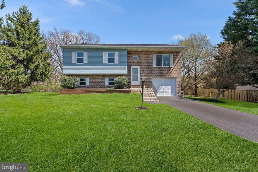 Welcome to this spacious split-foyer, single-family home that offers comfort, functionality, and room to grow. A large driveway leads to a 1-car attached garage, providing plenty of parking and convenience. Step inside to find easy-to-maintain flooring throughout the upper level, connecting the bright living room to the dining area and fully equipped kitchen—perfect for everyday living and easy entertaining. The home features three generously sized bedrooms with plenty of natural light. Head downstairs to a large finished basement, offering flexible space for gatherings, movie nights, or even a home office, along with a second full bathroom for added convenience. Outside, the expansive backyard is a great spot to relax, play, or start your dream garden. This home has the space and layout to make it truly your own. Schedule your tour today and imagine the possibilities.