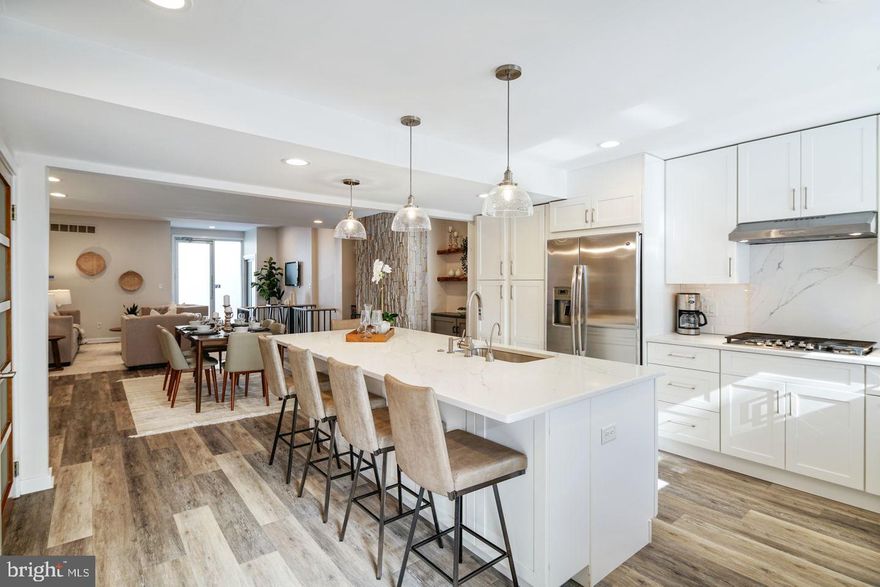 Welcome to this stunning, move-in ready home at 235 Catharine Street! With its traditional exterior and contemporary interior, this recently renovated home boasts over 3,700 sq. ft. of living space on 4 levels, offering 4 spacious bedrooms, 4.5 baths, a den/office/gym and 2-car gated PARKING in the heart of Queen Village within the desirable Meredith school catchment. Walking in you’ll be greeted by the large open concept first floor, the dining and living room make for a perfect entertaining space. Further back, you’ll find the brand new gourmet kitchen, which showcases quartz countertops, lots of cabinet space, an added window, and an oversized sink. Reclaimed wood shelves on either side of the gas fireplace finish off the beautiful aesthetic of the first floor. At the rear of the first floor, you'll find a large coat closet and a powder room before the exit to your private patio and parking area. This property runs from street to street, Catharine to Fulton St, offering easy access to the rear of the home. Two separate entrances to the lower level give you access to a finished all-purpose room and a separate area you can turn into a generous guest suite, future gym, or office/den space. Walking up to the 2nd floor, there are two oversized bedrooms with ample closet space in each, and a second living room between the two. Finishing this well thought out design are the stacked washer and dryer, a linen closet, and a full bath. The third floor houses another bedroom that can be used as a private office/den with its own full bathroom. The spacious primary room is brightly lit by natural light, and houses a walk-in closet as well as a large en-suite bathroom with an oversized soaking tub and separated walk-in shower. The roof is accessible through the master bedroom with easily pulled-down stairs, and it is possible to add a future roof deck. The seller recently replaced both furnaces, both AC condensers, the water heater, and added a third zone of AC in a mini-split system for additional cooling on the 3rd floor. This property is within walking distance to several parks, Philadelphia's Waterfront, Shopping, the local Farmers Market, and Headhouse Square. Make your appointment today!