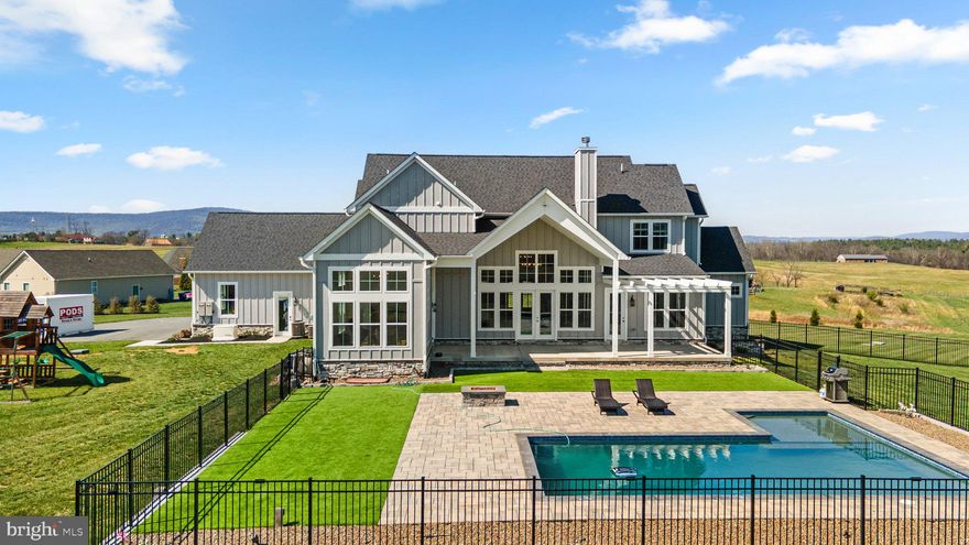 This stunning custom-built home blends timeless style with elevated modern finishes—inside and out. From the moment you arrive, you're greeted by a charming & spacious front porch, and panoramic mountain views that set the tone for what's inside.

Step into a show-stopping great room with vaulted ceilings, a statement brick fireplace, and a full wall of windows flooding the space with natural light. The chef’s kitchen is equally impressive, featuring an oversized island, high-end appliances, soft-close cabinetry, and designer backsplash. The dining room features a vaulted ceiling and walls of oversized windows- Direct access to the patio and pool area makes it perfect for entertaining. Large walk-in pantry offers exceptional storage with custom shelving systems, multiple levels of organization, and space for small appliances, bulk items, and cleaning tools. Also located on the main level is a well-appointed mudroom with direct access to the 3-car garage, custom drop-zone storage potential, and an additional laundry hookup for added flexibility. A stylish half bath is conveniently located for guests, and a dedicated home office sits just off one wing of the dual primary suite—ideal for those who work from home or need a quiet retreat.

The main-level primary suite is generously sized and positioned for privacy and convenience. This spacious retreat features 10-foot ceilings, recessed lighting, and large windows that provide natural light. Complete with sitting area that leads to the back patio.

The main-level primary bathroom is a unique retreat, boasting dual "his and her" wings with vanities and walk-in closets, meeting in the middle at an oversized shower with designer tile, and a spa-like vibe. 

Upstairs, you’ll find two generously sized bedrooms connected by a Jack-and-Jill bathroom, featuring separate vanities on each side of the shared bath. A third upstairs bedroom is served by a full hall bath, ideal for guests or additional family members. Just off the landing is a versatile flex space, perfect for a teen hangout, playroom, secondary office, or quiet reading nook—designed to adapt with your lifestyle.

The fully finished walk-out basement offers incredible versatility and nearly a home within a home. With two additional bedrooms and two full bathrooms, it’s perfectly suited for guests, extended family, or multi-generational living. A spacious entertainment zone anchors the level with a large media area, game space with ping pong and billiards, and a full wet bar featuring sleek cabinetry, quartz counters, and a beverage fridge. There’s also a dedicated office for those working or studying from home.

Step outside to your private oasis—where a heated saltwater pool, pergola-covered patio, and professionally landscaped yard await. Whether you're lounging by the pool or enjoying a quiet evening by the fire pit, this home was built to impress in every season.

Don’t miss the rare opportunity to own a home that combines luxury, function, and panoramic views in one of Middletown’s most sought-after settings. Additional recent upgrades include a whole-house generator and top-of-the-line water filtration system.