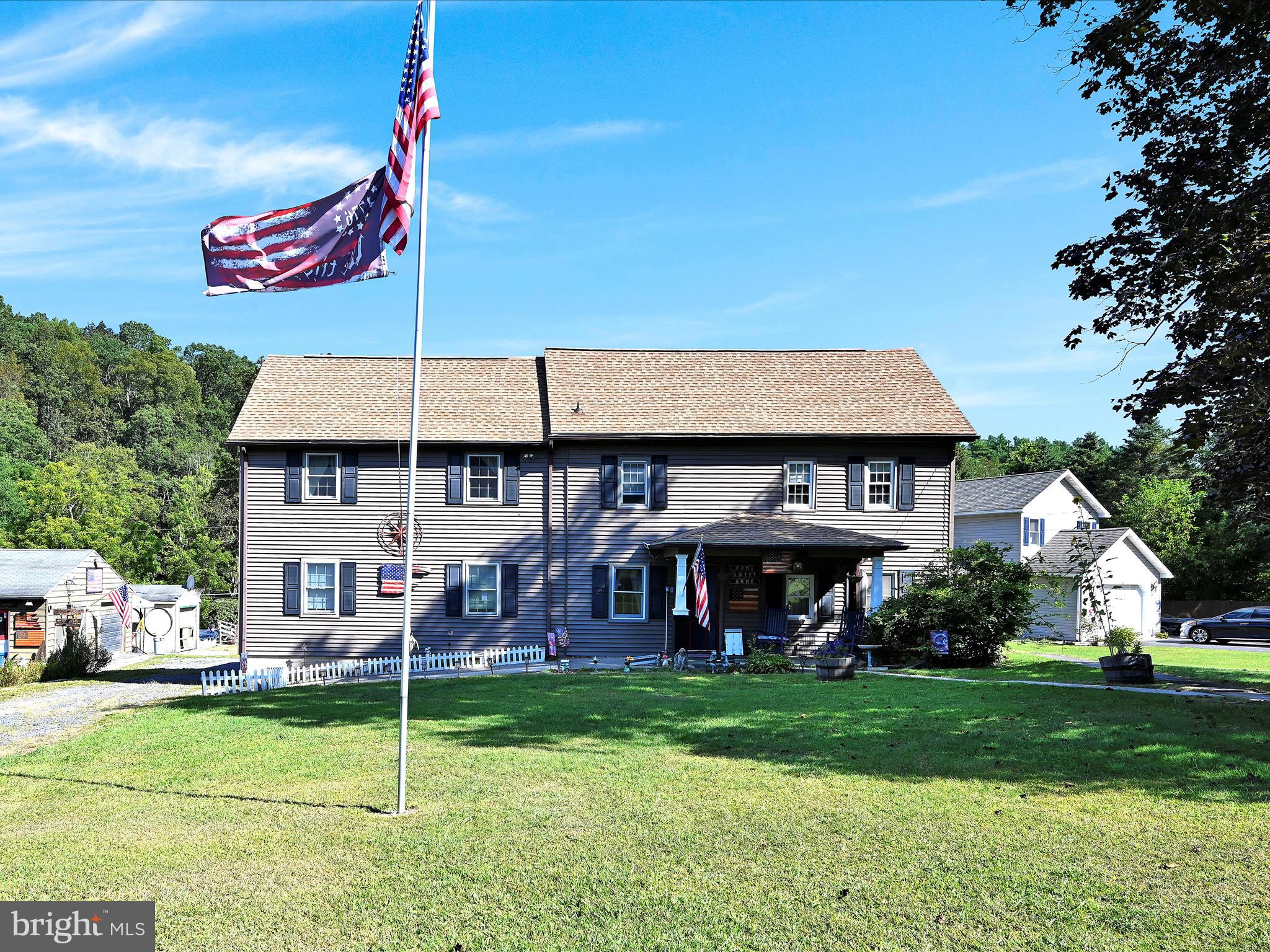 Welcome to a truly one-of-a-kind 5.5-acre property that offers the perfect blend of rustic charm, natural beauty, and everyday comfort. At the heart of the property sits a historic old farmhouse, rich with character and original details, including wide-plank wood floors, exposed beams, and rooms that still showcase their original log home interiors. Thoughtfully expanded over the years, the home now includes a massive open-concept living and dining area that flows seamlessly to a large rear deck with a pergola — an ideal space for entertaining or simply enjoying the peaceful surroundings. New roof with transferrable warranty. The kitchen is well-equipped with a center island and opens to a cozy covered patio featuring a porch swing — a perfect spot for morning coffee or evening sunsets. A laundry room and half bath are conveniently located just off the kitchen, along with a main-level bedroom that includes a closet but could be opened back up to restore the home's original layout.
Upstairs, you’ll find four generously sized bedrooms. Two remain true to the home's historic roots, with exposed beams and vintage charm, while the other two reflect the updates and newer construction of the addition. Additional foyer areas on both levels provide the perfect opportunity for small office spaces or reading nooks, offering versatility throughout the home.
Outside, the land is a rare find — combining large open pastures, gently wooded areas, and a scenic stream that winds along the back of the property. It's ideal for those seeking space to relax, garden, or raise animals. For equestrian enthusiasts, there are horse stalls already in place. The fenced-in garden area is ready for your next harvest, while multiple outdoor features — including an above-ground pool, fire pit area, two decks, and a carport — add to the lifestyle appeal. Two sheds sit on the property: one fully finished and currently used to display handcrafted wood items, and another for general storage.
Whether you're dreaming of a quiet country escape, a small hobby farm, or a place to create, this property offers a rare opportunity to enjoy the best of both worlds — historic charm and modern living in a serene, private setting.
This home is being sold as-is, with select furniture remaining and other items available for purchase. Contingent on seller finding new home.