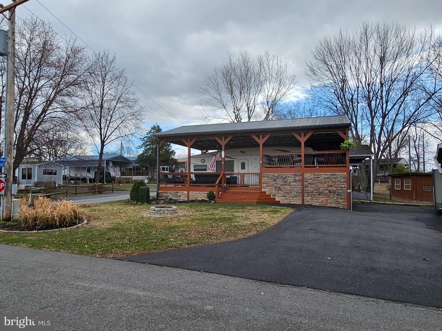 Situated on the corner of Yogi Bear and Soda Pop sits a property so meticulously taken care of and thought through property with SEWER! Beautifully landscaped & has Frontier internet. 

Talk about Home away from home! Make this spot your seasonal getaway in Riverbends Campground. Riverbend is 400 Acres of SEASONAL recreational campground full of amenities located on the Potomac River in Falling Waters, Wv.  Within a drivable distance to most of the Quad state area. 
OPEN APRIL 1 - NOVEMBER 1 - This is a fun & entertaining community, yet relaxing. Financing Could be available. They require a minimum of 25% down of purchase price or appraised value. 

Massive Stick Built Pavilion with a metal roof, gutters, downspouts and fully wired with electric for all the needs including a wired Generator plug! Walk right up through the wide staired, double gated entry to the porch. This outdoor oasis is spacious enough to be the hostess with the mostest with a 2-level deck surrounded by patio lights, sunshade blinds, and seating for many. You'll definitely want to make your memories here. The entire back side of the upper deck has a bar with bar seats and its own outdoor side by side refrigerator and new Ice maker line installed to keep those drinks cold all season. These owners have thought of it all. Equipped with lighting systems through all the stairs, patio, 3 ceiling fans with lights keeping that hot summer air flowing on timers and with remotes for the fans. You really must see all these features in person to appreciate. Over 300 metal balusters and glazed stonework around the foundation giving the deck a more luxury feel. The driveway is paved and has ample parking; a flat yard centers a block firepit for those campfires and s'mores. Housed under this 12 Ft + tall pavilion is a '04 5th Wheel Cedar Creek camper that also has some upgrades including a new larger Magic chef fridge, 8 all new LED light system that has 3 color tones to choose from, 2 Smart Tvs, a new receiver system that is wired to 2 speakers outside for your music and Tvs as well as providing audio inside the camper. The bedroom is a queen size bed with extra storage, Stall shower and bath in the upper part, sofa sleeper in the living room. Under the top deck is a well thought out garage workshop area big enough to house a small car or the 2017 Lifted Ez Go Golf cart that conveys with a full offer. It also has a radio & speaker system, under glow lights and more. Real Nice. The garage has a block foundation and concrete floor as well as Pvc panels on the ceiling that connects to downspouts to keep rainwater out. Lights and outlets all wired for your workshop needs with cabinets. 100G Propane tank, Deck Box, All Patio Furniture, Bike racks, Tool Racks all convey. Join the Riverbend Boat Club. Call today for your personal tour. Approx. 10 miles of Deep water on the Potomac River access for boating, fishing & swimming. Yearly membership ($1,987) plus a $200 initiation fee for new owners, includes water, sewer, electric, trash and the park amenities such as 3 pools, putt putt course, Horseshoe club, Boat club, Poker runs, Trick or Treat, Christmas in July, live bands, basketball court, tennis court, fireworks, car show, Church, restaurant, bar, convenience store (Great food), playground, volleyball, ball field and much much more. Bring your golf carts, water toys and come enjoy life!