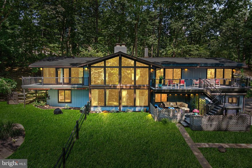 Although you will feel like you are miles away from the hustle and bustle of everyday life, it takes just minutes to get to everything from this stunning 4 bedroom, 2.5 bathroom McElroy contemporary home.  Nestled on a private one-acre lot  at the end of a quiet cul-de-sac this  stunning midcentury modern house offers picturesque views throughout the home,  welcoming the natural setting inside,  The home offers a fabulous,  flexible, open floor plan which is spacious and functional to meet the demands of today's busy lifestyle.  As you enter the home  you are  captivated by the stunning views, created by the floor to ceiling glass walls and windows as well as the  the vaulted ceiling  architectural accents.. The  main floor  features an updated kitchen  with custom cabinetry,  soapstone counters, custom tile backsplash, Bosch appliances and a center island/breakfast bar, as well as a casual dining area; a flex area which could be used as a library or entertaining room,  a dining area,  and very spacious family room with wood burning fireplace  and a perfect view of the back yard oasis.  On the main level you will also find a spacious Primary Bedroom with a walk-in closet and updated ensuite bathroom with soaking  tub; as well as a  private balcony  where you can star gaze  or take advantage of  stunning bucolic views 4 seasons of the year.   Three additional sets of sliding glass doors lead to balconies off the main level living areas making the  main floor perfect for entertaining large or intimate gatherings  A powder room completes the main level.  On the Lower Level you will find 3  additional spacious bedrooms, a full bathroom, plus  centralized  entertainment room with a built-in speaker system, wood fireplace and sliding doors to a large balcony which walks out to the back yard and pool area. . The laundry room and access to the two-car garage complete the lower-level. The large private back yard is  truly a personal sanctuary and offers  a beautiful in-ground salt water pool ,  plenty of space for your firepit, gardening areas and more!. Updates  completed in 2024-25 to the home include new exterior painting,  all new UV protection windows installed, all new sliding doors installed,  new sidewalks and stairs to the front, updated kitchen and bathrooms, and new A/C  system.   This is a very special, enchanting,   one of a kind property that is a  a home,  a sanctuary, and a  historical McElroy architectural design.. ......Book your appointment today!