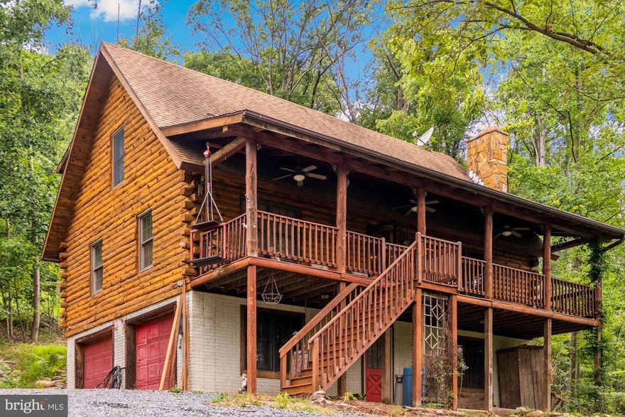 High speed cable internet through Frontier.  Beautiful Log home nestled among the trees, backing to Sleepy Creek Wildlife state park, which is 23,000 acres with a 205-acre lake.   The Sleepy Hollow community has a private 5-acre lake with beach and pier, perfect for swimming, boating and fishing as well as a baseball diamond and outdoor pavilion with electric perfect for private family events and fun.  24X20 shed is on the property. This classic log home features 3 bedrooms and a bright, open layout and country kitchen. 2-Car attached garage along with plenty of space for parking in gravel driveway. This log home is a rare find in an excellent location. Come see today!