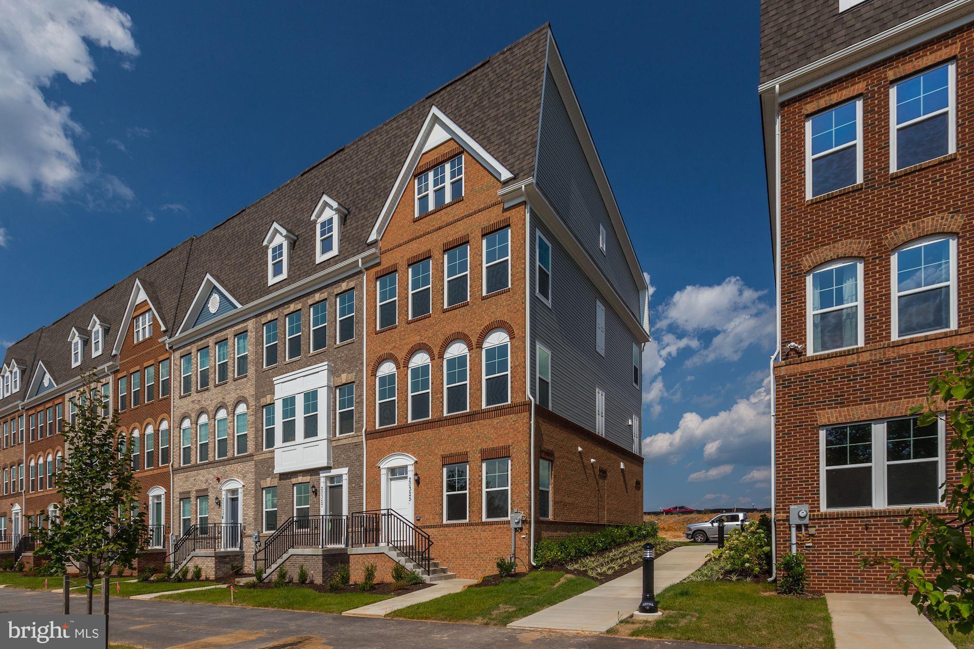 Upgrades galore!! Walls of windows, beautiful flooring, open floor plan, high end tile, upgraded counters and cabinets, and it's an end unit, so you have more natural light! Make an appointment today!
