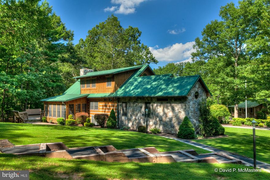 BRING THE FAMILY, THE LAMBO, THE MODEL T, & THE VW BUS! About 4 miles from the arts community of Berkeley Springs, 9 miles from I-70. AN EXTRAORDINARY LUXURY ESTATE on 35 sylvan acres. Multiple structures and features including a 3 BEDROOM LOG COTTAGE , a LUXURY 8 CAR SHOWROOM-GARAGE WITH LIVING QUARTERS ABOVE, ANOTHER SMALLER  COTTAGE, ANOTHER GARAGE WITH OFFICE OR APARTMENT ABOVE, AN ENCLOSED PAVILLION WITH FIREPIT, A GAZEBO, ANOTHER 1 CAR GARAGE AND A SHED!  ALL OF THESE STRUCTURES ARE OF THE HIGHEST QUALITY WITH ABUNDANT FEATURES AND FINISHES. THEY WERE CUSTOM BUILT AFTER 1990 AND HAVE SEEN VERY LITTLE USE, BUT HAVE BEEN IMPECCABLY MAINTAINED. MOST HAVE METAL ROOFS. Property fronts on a High quality FISHING CREEK.  Please see documents attached for floor plans and measurements. This is a newly merged parcel. Assessment and tax info is not exact. Don't forget your fishing rod and kayak or Grandma!  Summer/year round camp for grown-ups.  Peaceful, beautiful, private.  Rare opportunity.  Note the description in listing of  interior rooms  of the Main Cabin. PLEASE click the documents link for full floorplans of most structures! We have already listed another portion of this complex (listing WVMO115124) and will be listing several other improved parcels including another unbelievable garage/living combo shortly.