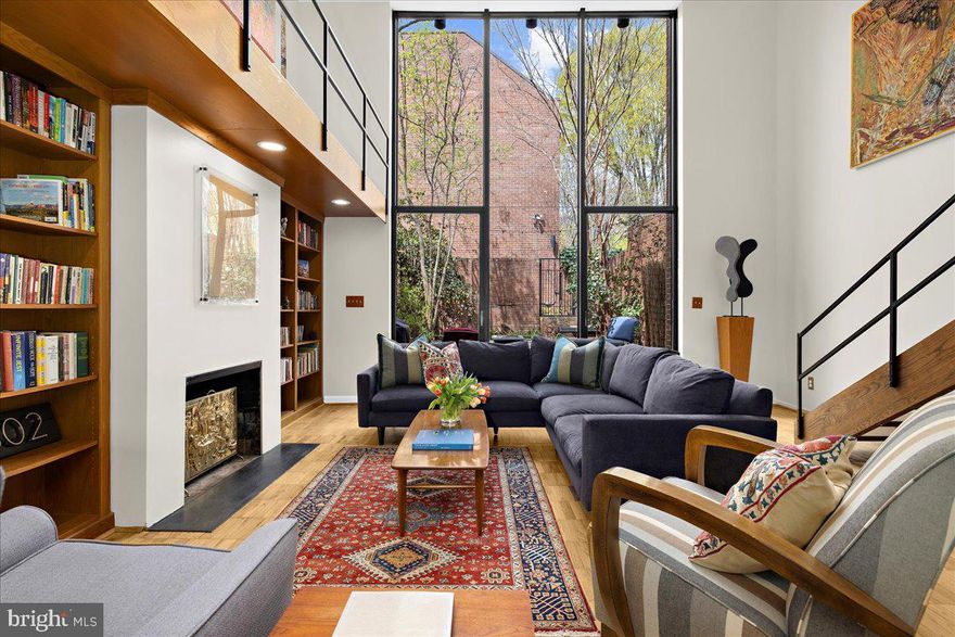 Architectural Masterpiece by Hugh Newell Jacobsen in the Heart of Historic Bolton Hill
Welcome to 302 W Lafayette Avenue, an exceptional townhome in the coveted Bolton Hill neighborhood, designed by internationally renowned architect Hugh Newell Jacobsen—celebrated for his iconic work on the Jacqueline Kennedy Onassis residence on Martha’s Vineyard, the American Embassy in Paris, and the extraordinary expansion of the U.S. Capitol complex.

This rare architectural gem provides 2,496 square feet of finished living space and features four bedrooms and three and a half baths, seamlessly blending clean-lined modernism with timeless sophistication. A private brick courtyard—complete with a tranquil koi pool, flowering trees, and direct access to the community greenspace—offers a serene outdoor retreat within the city.

The entry level welcomes you with a bedroom suite and full bath, a dedicated laundry area, and a stunning catwalk that overlooks the dramatic main living space. The living room, crowned by soaring two-story atrium windows, is bathed in natural light and anchored by custom built-in bookshelves and a wood-burning fireplace—a perfect setting for both quiet evenings and sophisticated entertaining. Expansive wall space invites the display of a curated art collection.

Upstairs, the primary bedroom is filled with natural light, accompanied by two additional bedrooms and a full bath. A finished attic level provides a quiet escape, ideal as a den, home gym, or creative studio, with ample storage tucked seamlessly into the design. Recent updates include new HVAC system in 2023, ductless system in attic in 2024, and new roof in 2021. 

Truly one of Bolton Hill’s most remarkable homes, 302 W Lafayette is a rare opportunity to live in a work of art by one of America’s most celebrated architects, all within minutes of cultural landmarks, private schools, and the vibrancy of downtown Baltimore.