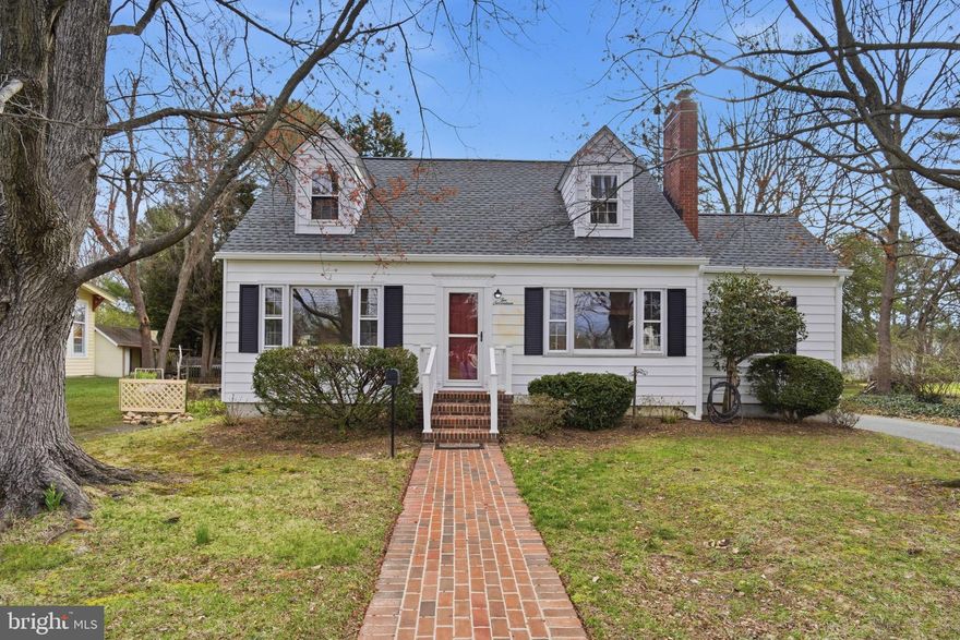 Charming and full of potential, this 3-bedroom, 1.5-bath Cape Cod home offers a prime in-town Chestertown location with thoughtful updates already in place. New roof (December 2025), heat pump (2022), and new carpet upstairs provide peace of mind, while classic features like hardwood floors, abundant natural light, and a wood-burning fireplace add warmth and character. The flexible layout includes a main-level bedroom and full bath, a formal dining room, and a bright living room. Upstairs, two additional bedrooms and a half bath, easily converted back to a full, offer room to grow. A bonus room off the main level is perfect for a home office, mudroom expansion, or hobby space. The sunroom connects seamlessly to a private backyard. A sizable driveway and two car garage offer ample off-street parking. Architectural plans for a full renovation and addition are available with an acceptable offer. This is an incredible opportunity to customize and add value in a sought-after location. Just a short stroll to Downtown Chestertown, Washington College, and the Chester River, this home offers both convenience and long-term potential.