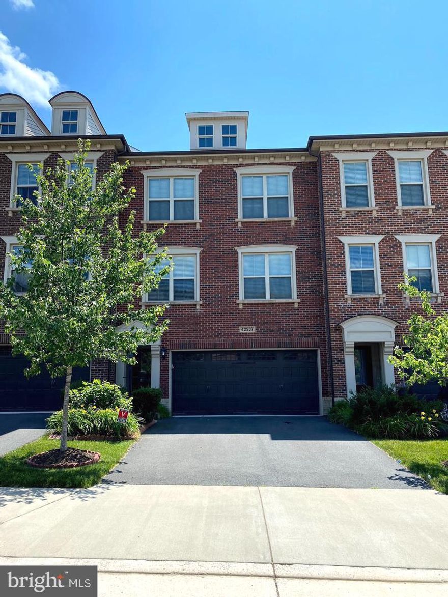 Step into a home where comfort, elegance, and everyday living come together beautifully. Nestled in the heart of Ashburn’s highly sought-after Brambleton community, this stunning Winchester Homes Paxton model with a 4-foot extension invites you to experience a lifestyle you’ve been waiting for.
From the moment you walk in, you’ll feel the warmth of a thoughtfully designed space that truly feels like home. The main level welcomes you with rich hardwood floors and an inviting flow—from the formal living and dining rooms where memories are made, to a private office perfect for quiet moments or working from home. At the heart of it all is the expansive family room, ideal for gathering with loved ones, seamlessly connected to a gourmet kitchen that will inspire your inner chef. Featuring a large center island, elegant cabinetry, granite countertops, stylish backsplash, and soft pendant lighting, this kitchen isn’t just functional—it’s where life happens. Step out onto the spacious deck and imagine morning coffee or evening sunsets in your own private retreat.
Upstairs, the primary suite offers a peaceful escape at the end of the day. Unwind in your spa-like bath with a soaking tub, glass-enclosed shower, dual vanities, and a generous walk-in closet designed to keep everything effortlessly organized. Two additional bedrooms provide comfort and flexibility for family, guests, or creative space, while the conveniently located laundry room makes daily living that much easier.
The lower level extends your living space even further, featuring a cozy recreation room with a fireplace—perfect for movie nights or relaxed weekends. With a full bath and walk-out access to a private fenced patio, it’s an ideal setting for entertaining or simply enjoying quiet outdoor moments.
Living in Brambleton means more than just a beautiful home—it’s a vibrant lifestyle. From scenic trails and parks to community events, shopping, dining, and top-tier amenities, everything you need is right at your fingertips. Plus, with easy access to major highways, Dulles Airport, and the Silver Line Metro, convenience is always within reach.
This isn’t just a home—it’s where your next chapter begins.