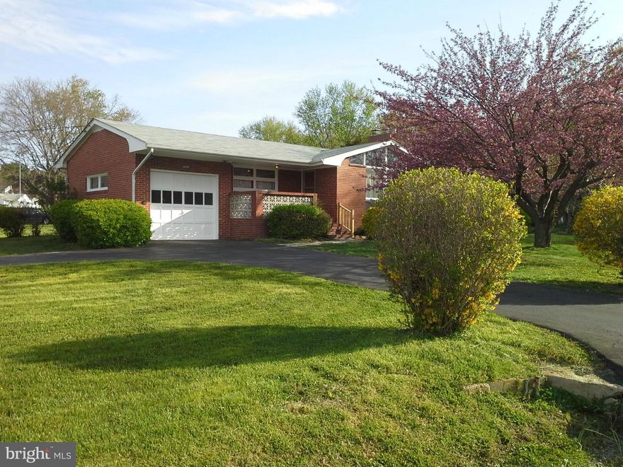 Classic styled brick rancher on wonderful level lot with mature landscaping. One car garage and full basement with pool table and fireplace/wood stove. Lots of storage. This roomy home features a cathedral ceiling in the LR, Hardwood floors under carpet, lots of windows and new ceramic tile floor in bath.  This location is GREAT with easy access to I95, local restaurants and shopping. Take a look!