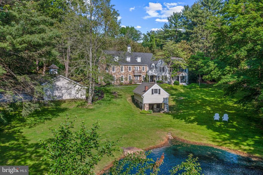 Welcome to Greendale Spring! The original portion of this estate started with a 19th century springhouse & tenant house. For the 1st half of the 20th Century, this property was part of Greendale Farm. The property now offers nearly 6,000 Sq. Ft. of living space. The first thing you notice is the spring-fed pond with a fountain. One passes around the pond to the detached 3-car garage & a large parking area. The current owners significantly expanded the house in 2007 with a beautifully detailed 2-story addition that perfectly integrates into the existing 19th century home. It was designed by McIntyre Capron & Assoc. & constructed by MAF Homes. Its unique features include masonry walls, two sets of Juliet balconies facing the pond, a cozy balcony overlooking the rear yard, unique mock dormers & a custom cupola. The first thing you’ll notice inside is the wide plank, custom milled Pine flooring that extends the entire length of the first floor along with the random width vertical beadboard walls. The powder room, a large walk-in coat closet & a caterer’s kitchen are accessed from the foyer. The kitchen was remodeled in 2016. This space provides an abundance of storage in the custom cabinetry. Picture windows overlook the rear yard & pool. The cabinets are topped with marble counters & a bead board backsplash with a porcelain farmhouse sink. The central island has walnut counters & space for 2 barstools. A peninsula between the kitchen & the dining room can accommodate 3 more barstools. A SubZero fridge/freezer flanks one wall, surrounded by floor to ceiling pantry cabinets. A 36” Wolf gas range has an oversized copper exhaust hood. The dining room has banks of windows & doors along all three walls & a wood burning fireplace. In the original tenant house, a cozy living room with a gas fireplace and a bank of built-in bookshelves & cabinets is the perfect space to relax after a long day. Connected to this room is another cozy den with a wall of built-in cabinetry. The caterer’s kitchen that has a 2nd stove, beverage fridge and sink with more custom inset cabinetry & a large utility closet that has more custom cabinetry, another sink and a broom closet. Just off the foyer, there is a 1st floor bedroom with a walk-in closet. Connected to this bedroom is a full bathroom with a stall shower. Along the front, the hallway takes one past the staircase to the 2nd floor and down to the family room. There are windows on two of the walls and a set of French doors for access to the rear yard. All of the space above the family room, bathroom & bedroom on the 1st floor is the primary suite. The sleeping chamber is vaulted & beamed with French doors leading to the rear balcony. There are built-in display shelves & cabinetry. There is a walk-in closet with custom shelving, cabinetry & built-in dressers. The primary en-suite has 2 sinks, a free-standing soaker tub, a walk-in shower and a toilet room. There are 3 sets of closets to provide additional storage in the hall. The laundry room is tucked off the hallway, as is a dedicated home office. There are 3 more guest bedrooms and a hall bathroom. There are two small rooms on the 3rd floor, along with attic space for storage. The entire basement under the 2007 addition is finished as one huge open space. There is ample room down here for a secondary sitting area, gym, game room or anything else you can imagine & includes a second powder room. Surrounding the kitchen & dining room, a spacious brick patio provides ample outdoor entertaining space. There is also a delightful Williamsburg inspired garden shed tucked into the corner.  Stone walls surround the patio with 2 sets of stairs that lead one up to the inground pool. The hidden oasis is a perfectly designed rectangular pool with a large deck area.  Ample space for dining, lounging and entertaining is provided around the pool! Greendale Spring is a remarkable estate property, tucked away from the crowds yet convenient to so many things!