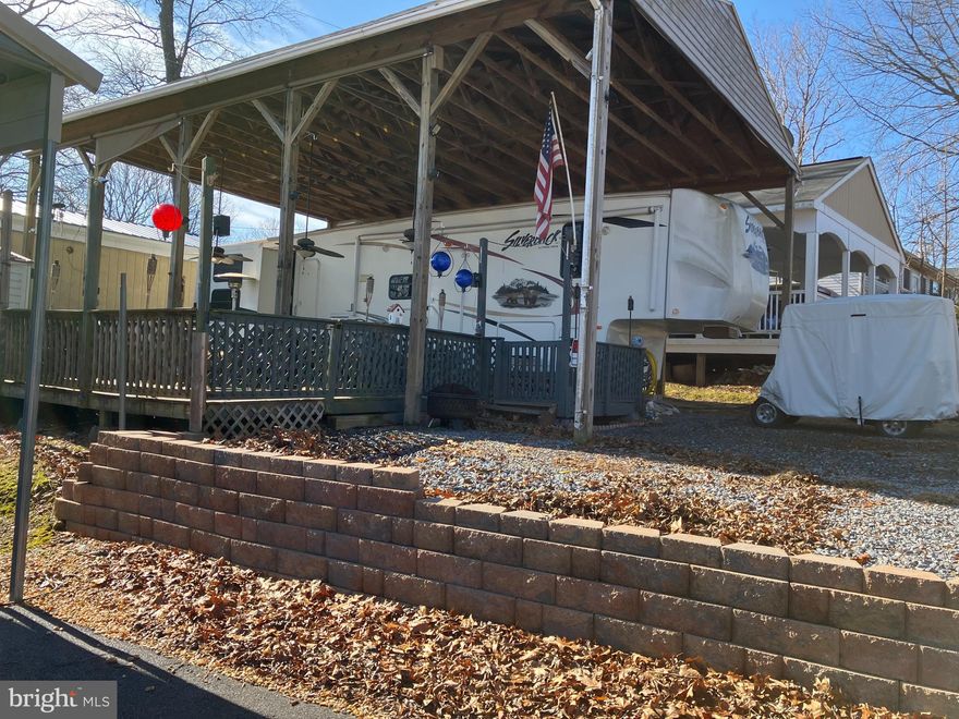 Are you looking for a place to relax on the weekends?   Block 25 Lot 8 on Poison Oak is a wonderful camping lot close to all the amenities that River Bend seasonal campground has to offer.   This lot includes a large 2-Bedroom ,1.5 bath 2011 5th wheel Silverback Cedar Creek camper that sits under a very large pavilion.  The camper has a primary bedroom with a queen bed, plus an additional bedroom with 3 bunkbeds.  There's a large deck with room for hosting and relaxing.   

This lot is on sewer, which means no worries about ever pumping out the tanks!  The shed has electric and comes with a full-size refrigerator inside. Included with the sale you'll get multiple TV's, outdoor speakers, 2 grills, a small outdoor refrigerator, a picnic table, and a camera system.  There's ample parking for cars, golf cart, boat, etc.  The golf cart in the photos can convey for an additional $4,000.  

River Bend Campground sits along 12 Miles of deep water on the Potomac River.  Great for boating, fishing & swimming. Yearly membership includes water, sewer, electric, trash and all the park amenities that River Bend has to offer.  All 2026 Dues are already paid in full.  Enjoy 3 pools, putt putt, horseshoes, basketball, tennis, fireworks, car shows, a restaurant/bar, laundry facilities, playgrounds, ball fields and much more.

 Call for your tour today!