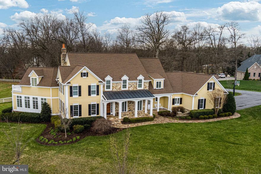 Custom French Provincial estate home in sought after Paternal Gift Farm!  Premier lot in the heart of this beautiful equestrian community - central to the neighborhood, yet property lines shared only with the horses!  Bring your own horse or simply enjoy viewing them right from your own backyard!  This classic home has been exceptionally maintained and loaded with upgrades, including a two-level 1200 sq ft sunroom/office addition, natural hardwood floors and extraordinary customized trim and molding throughout. Natural hardwoods include 3/5/7 alternating width oak floors (finished in place) throughout entire downstairs and the majority of the upstairs.   The home boasts three finished levels and an open and airy floor plan with tons of natural light emanating thru the kitchen, sunroom and the entire home.  As you enter through the stately wood front door, the two-story foyer beckons you to the expansive great room with gas fireplace and majestic hearth and mantle, French doors to beautiful stone patio, entry to light-filled large sunroom, and connection to office with custom Cherry built-ins.  The adjoining kitchen will make you want to cook all day with granite countertops, gorgeous pendant lights over center island with bar seating, upgraded windows, 42” custom cabinets, tile backsplash, Subzero refrigerator, GE 6 burner gas stove, double-oven, Bosch dishwasher, microwave, space for large table and sideboards.  Rounding out the first floor is a formal dining room, two powder rooms, a laundry room with washer and dryer and chute, and plenty of closets and storage.  Top level features 4 bedrooms, a bonus room, a second office and three full baths. Owner’s suite has double-door entry, beautiful hardwood floors, gas fireplace, wood blinds, access to a huge office (bonus room), French doors to balcony and ceiling fan.  En suite bath boasts quartz counter tops, dual sink vanity with Waterworks faucets from France, free-standing soaking tub, custom tiled shower and a never-ending closet with loads of Cherry built-ins, and even a fridge for late night cocktails!  Other three bedrooms are large – two sharing a bath with Restoration Hardware vanity and the fourth bedroom with its own full bath, attached bonus room for games/reading/hobbies and tons of storage.  Lower level is completely finished and invites socializing and getting fit with large family room with built-in storage seating, game room, exercise room with mat floor, mounted ballet bar with fully mirrored wall, full bath, workshop and utility room for home mechanics.  Additional features include 16 kw generator, 4-zone HVAC, central vacuum for all 3 floors, Leafguard gutter system, water treatment system, whole house humidifier, and French doors at every exit.   New roof 2015, transferrable warranty (25 years workmanship, material and labor 50 years)
Spectacular 3-car garage with built-ins, grand arched doors, granite floor, extra fridge and driveway with basketball hoop and room for 9 cars easily.  Enjoy the rich scenery from multiple outdoor seating spots, front and back. Take in beautiful sunsets over the pasture from your Tuscan fountain seating area and grow veggies in the vegetable garden.  Relax at the end of the day with a glass of wine while sitting on the back porch and catching up on the day’s events. Professional mature landscaping with cherry blossoms and extensive hardscaping.  This home has it all – soaring ceilings and grandeur for all your entertaining needs yet this is a quiet home with peaceful spots to enjoy morning coffee or reading a book.  Surrounded by nature with both walking and riding paths, a community gazebo and fishing pond and a storage shed for boats and horse trailers.   Privacy and seclusion while close to major arteries, shopping, post office, restaurants and Schooley Mill Park.  Location, location, location!  This home is a shining star not to be missed!