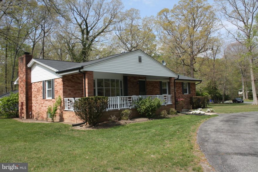 Classic brick rambler with charming surprises....great sunroom off large kitchen overlooking mature azaleias; circular driveway in front; large southern front porch, sunny bay window in living room, built in shelving with window seat; entertainment bar; cozy fireplace with mantel; newly installed carpet; freshly painted.  Estate sale..detached garage/workshop w/electricity. Public water & sewer.