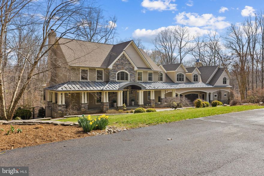 Indoor elegance meets outdoor paradise in this impressive 6-bedroom, 5.5-bath home. Dive into your own private retreat with an enormous inground heated saltwater pool with an expansive pool deck and automatic cover.  Entertain effortlessly in the adjacent outdoor kitchen nestled in a covered area outside the lower level with a TV, commercial grill, sink, and much more.  Perfect for gatherings all year round! For the true car enthusiast, this home features an extraordinary garage, designed to be a showcase for your prized collection. Whether you’re a collector, a hobbyist, or simply someone who appreciates fine automobiles, this garage is a dream come true—offering both functionality and the perfect stage to display your passion. The full bathroom ensures convenience, making it easy to clean up after working on your collection. Inside, the thoughtfully designed layout offers a main-level bedroom and full bath, ideal for guests or multi-generational living. The formal living and dining rooms provide classic elegance, while the gourmet kitchen with a central island flows seamlessly into the inviting family room with a fireplace and built-ins. Step outside to the screened porch, where you can enjoy the beauty of the outdoors in comfort. Upstairs, you'll find four additional bedrooms, two baths, and a dedicated laundry room. The primary suite is a true retreat, featuring an oversized bedroom with a sitting area, fireplace, and private balcony. The spa-like ensuite bathroom includes a stunning soaking tub, walk-in shower, dual sinks, and an enormous walk-in closet. Completing this level is a gym with pool views and a private office with built-in cabinetry. An adjacent unfinished space with separate entrance, offers endless possibilities. The lower level is an entertainer's dream, boasting a full kitchen, great room with fireplace, bedroom, full bath, and direct access to the outdoor entertaining areas. Unlimited space for gatherings large and small. Perfectly located with easy access to all local commuter roads, this extraordinary home is designed for those who appreciate convenience, quality, space, and style. Welcome Home!