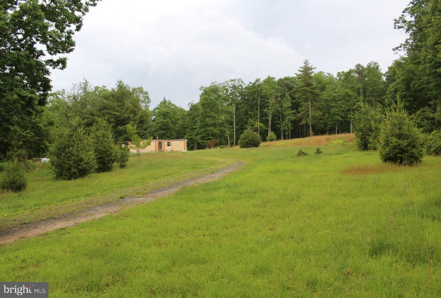 Build your dream home on a relatively flat, secluded, unrestricted piece of land,  12.2 acres of privacy, situated right on the West Virginia/Virginia Line.  There is a 10 x 40 Single Wide Mobile Home with 2 bedrooms and 1 bath on the property.  The property features a private well, septic and electricity.