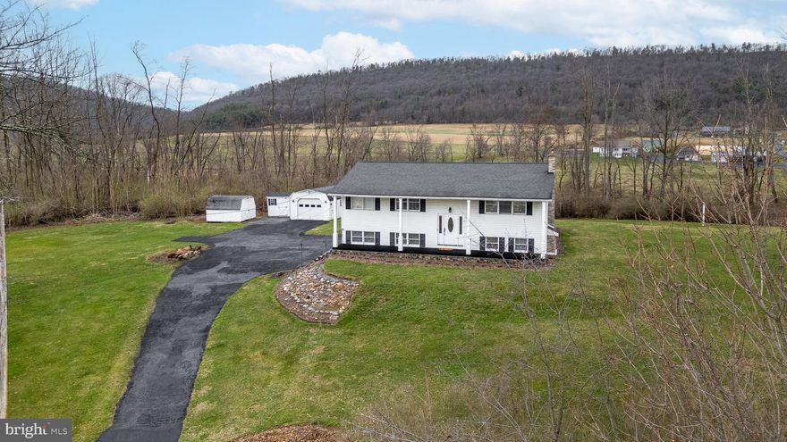 Welcome to 114 Vulcan Lane in Millheim—a meticulously maintained home set on a partially wooded 2-acre lot with beautiful views from both the front porch and back deck. Inside, you'll find oak hardwood floors throughout the main living spaces, an updated kitchen, a primary ensuite with a renovated bathroom, two additional bedrooms, and a recently remodeled full bath. The walk-out lower level offers endless possibilities with a mudroom, two bonus rooms, a cozy family room with a pellet stove, a laundry room, and a half bath. Additional features include a one-car garage, radon mitigation system, and a newer roof—offering comfort, privacy, and convenience in a peaceful setting.