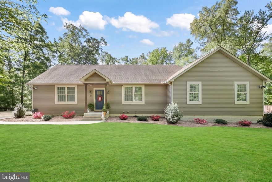 Welcome home to 7664 Muscoe Place, where pride of ownership shines throughout. Nestled on 4.40 acres with no HOA, this property offers the perfect blend of privacy and space, creating a true park-like setting with mature trees providing shade across the perfectly landscaped yard. These original homeowners have thoughtfully enhanced the land with wooded trails, ideal for riding go-carts and exploring, and added a second driveway—perfect for RVs, campers, or extra parking. Beautiful landscaping, cherry trees, and a peaceful cul-de-sac location complete the outdoor appeal.  Inside, this expansive 5,100+ square foot home welcomes you with an open floor plan, abundant natural light, and new LVP flooring throughout the main level. The remodeled chef’s kitchen is a standout, featuring new cabinetry, modern appliances, and stunning quartz countertops with over 80 square feet of workspace—perfect for everything from large meal prep to homework stations. The spacious island includes an additional sink with a reverse osmosis drinking water system, and a convenient butler’s pantry adds extra storage and functionality.  The main level offers over 2,500 square feet of living space, including three bedrooms, two full bathrooms, and two half bathrooms. The family room flows seamlessly from the kitchen and offers serene backyard views. The primary suite is a private retreat with picturesque views, room for a sitting area, a large walk-in closet, and an updated ensuite bathroom featuring a zero-threshold walk-in shower.  Additional main-level conveniences include a mudroom with a half bath—perfect for keeping things organized—and a spacious laundry room complete with a pet wash or mop sink.  The partially finished basement adds another 2,500 square feet, with over 700 square feet already finished. This level includes three finished rooms, a full bathroom, a kitchenette, and an additional laundry hookup—making it ideal for guests, in-laws, or a separate living space. The epoxy-finished concrete floors add durability and style, and a walkout leads to a second patio with peaceful backyard views. A great-sized exercise room and storage room complete this level.  Additional home features include dual HVAC systems (one replaced in 2025), washer and dryer hookups on both levels, and multiple outdoor patio spaces for entertaining or relaxing. A custom school bus stop conveniently located out front adds to the home’s practicality. The property also features a shed with electricity and an RV hookup. This exceptional property offers space, flexibility, and comfort—all in a serene, natural setting with no HOA! It's just a short drive to Dahlgren, Caledon State Park, and historic Fredericksburg. Call for your tour today!