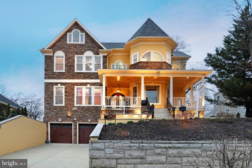 This is a truly remarkable residence in the heart of Brookland. One of the largest homes in the area, with over 5000 square feet of living space, this gorgeous  Contemporary Craftsman was custom built from ground up in 2011. It sits atop Round Hill, the 7th highest summit in all of DC, boasting views of the National Monument and the Basilica of the National Shrine of Immaculate Conception. This expansive home offers four levels of luxury, multiple decks, and an exquisitely landscaped yard - perfect for relaxation and entertaining. Step inside to discover spacious well thought-out living areas, featuring multiple fireplaces, creating a warm inviting ambiance. Storage is never an issue, with ample closet space and built-ins throughout. The chef's kitchen is designed for entertaining, and the home's elegant finishes provide the perfect blend of comfort and sophistication. Car enthusiasts and hobbyists will love the large two-car garage with an attached workshop, plus an extended driveway that accommodates four additional vehicles. This home is a rare find, combining space, elegance, and convenience in one of DC's most sought-after neighborhoods. Fully paid (35) Solar Panels on the roof convey.