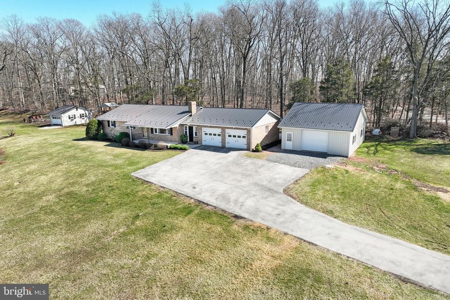 ONE Story Living Dreams---Discover the comfort and convenience of one-story living in this well-maintained BRICK rancher set on 1.67 acres in a rural setting. With a detached garage, attached two-car garage, and partially finished basement, this property offers versatility to suit your lifestyle! Inside, you’ll find 3 bedrooms, 2 full baths, and a beautiful main-level laundry (2020). Major improvements include a NEW roof (2020), NEW pole building (2020), and a NEW patio (2023)—perfect for outdoor entertainment and relaxation! Whether you’re seeking space for hobbies, storage, or simply more room to unwind, this home offers a range of possibilities—all with the benefit of a large yard, fresh air and open skies. Enjoy the tranquility of country living with the convenience of being just a short drive to Route 15 and nearby amenities. With so much to offer, you might just find that everything you need is already right here at HOME! Schedule your showing appt. to explore what this property could mean for YOU!