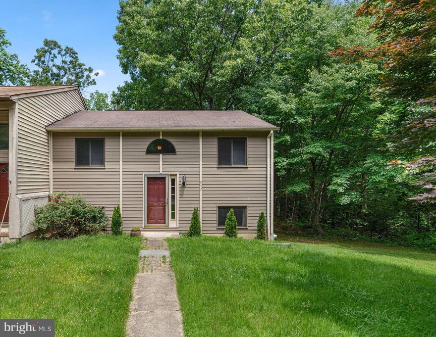 Welcome home to Ulmstead Gardens- a sought after community districted to Broadneck Blue Ribbon Schools with walking trails, sports courts and a community playground! Move right in to this turn key three bedroom and two bathroom end unit townhome on a private, wooded lot. Well maintained and ready for the new owner, this home features vaulted wood beam ceilings and an open concept main living level with beautiful hardwood floors and a deck overlooking the trees. Two bedrooms and a full bathroom can be found on the upper level with an additional bedroom and full bathroom on the lower level along with a rec room and spacious utility room along with slider door access to the private rear yard. Easy commuter access via major routes. Close to restaurants, shops and entertainment. Schedule your private tour today!