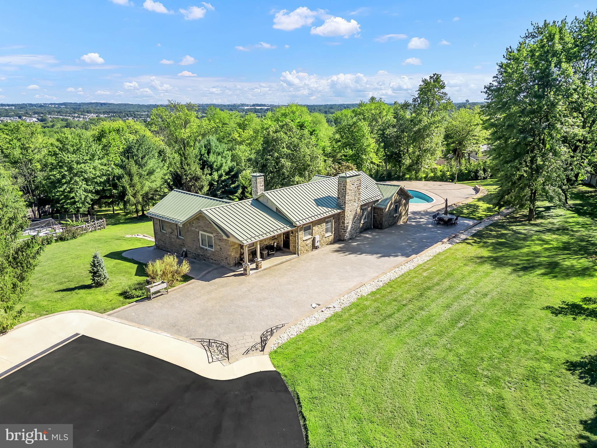 Exceptional Dual-Home Estate on Nearly 7 Fully Fenced Acres in Warwick Township
Welcome to 1851 Meetinghouse Road, a rare opportunity to own a stunning private estate with an automatic gate. This remarkable property features two separate residences and a 1,200 sq ft pole barn with a large attic, all enhanced by a host of high-end upgrades—perfect for multi-generational living.
The main house, a 2,900 sq ft stone residence fully renovated in 2021, blends classic architecture with luxurious modern finishes. It offers 2 spacious bedrooms, 2.5 beautifully updated bathrooms, and a 5-zone HVAC system. The gourmet kitchen is outfitted with premium Miele appliances and heated floors, while the sunroom and living room feature both heated floors and motorized blinds, providing year-round comfort and effortless style. Throughout the home, Andersen windows provide energy efficiency, natural light, and superior craftsmanship. A generator, large paver patio, and elevated views enhance both peace of mind and lifestyle enjoyment. The in-ground pool completes the resort-like outdoor living experience.
In-law house built brand new in 2023, is a fully independent 2,100 sq ft home featuring 3 bedrooms, 2.5 bathrooms, a 3-zone HVAC system, and a thoughtfully designed finished walk-out basement with heated floors—perfect for additional living space, a home gym, entertainment area, or extended guest accommodations. The walk-out basement provides direct access to the expansive grounds and offers seamless indoor-outdoor living.
The impressive 1,200 sq ft pole barn, accessed via a separate driveway, adds tremendous value and flexibility, with ample room for storage, garage use, workshop space, or creative pursuits, plus a large attic for additional capacity.
This extraordinary estate offers unmatched privacy, flexible living arrangements, and premium amenities—while remaining just minutes from shopping, dining, and major commuter routes.