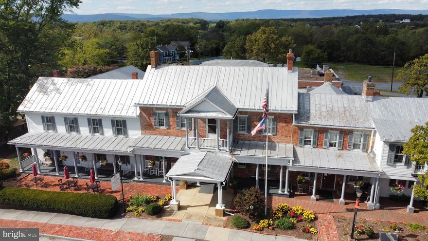 Unlock the potential of a timeless landmark with the Wayside Inn, a historic gem nestled in the heart of Middletown, Virginia. This unique property not only boasts a rich history dating back to the 18th century but also offers 22 suites all with bathrooms, 3 bars (tavern, bourbon & Speakeasy, The RED HAT), huge entertaining space for events.   This is a prime commercial opportunity with an expansive  land for expansion.  Just under 4 acres zoned B1.   With 4 acres of commercially-zoned land at your disposal, envision the expansion possibilities that could elevate this historic landmark into a thriving hub of activity.   Take advantage of the ample space to create a vibrant commercial district that complements the historic character of the Wayside Inn, making it a destination for locals and tourists alike.   Situated in the picturesque Shenandoah Valley, the Wayside Inn offers a scenic backdrop that enhances the allure of any commercial venture. The expansive grounds provide ample room for outdoor amenities, gardens, or additional structures to further enhance the property's appeal.   Benefit from the strategic location of Middletown, with easy access to major transportation routes. The Wayside Inn's proximity to popular attractions, historic sites, and a supportive local community makes it an ideal location for a successful and sustainable business venture.   Don't miss the chance to own a piece of history with a promising future. The Wayside Inn presents a rare investment opportunity where historic charm meets commercial potential. Whether you're an entrepreneur seeking a unique venture or a developer with a vision, this property is your canvas to create something extraordinary.
Seize the moment and transform the future of the Wayside Inn. Embrace the legacy, write the next chapter, and make this historic landmark a cornerstone of Middletown's thriving community.   Fully running and doing great, we have changed management and its now positive cash flow.   its prime for an owner occupant.   call for details and appointments.  Open to lease option and owner financing available.