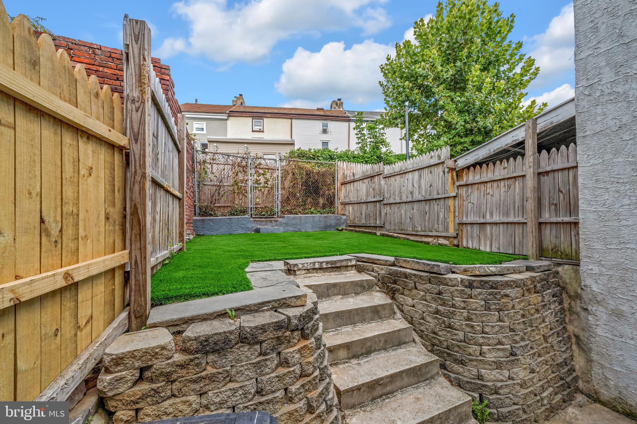 Discover your new home in the heart of Manayunk! Just steps away from vibrant Main Street, this beautifully renovated gem features 4 spacious bedrooms, 3 modern bathrooms, and an updated kitchen. The living room is bathed in natural light, creating a warm and inviting space with a white-washed brick wall. An updated half bath has been added to the first floor for extra convenience. Enjoy fresh paint and new flooring throughout, plus a back patio with private fencing and lush turf--perfect for outdoor relaxation. The primary bedroom boasts a generous walk-in closet, and double vanities in both bathrooms on the second and third floor offer added luxury. The entire home has been thoughtfully renovated and includes modern finishes across three spacious levels. Don't miss this opportunity for stylish living in such a prime location!