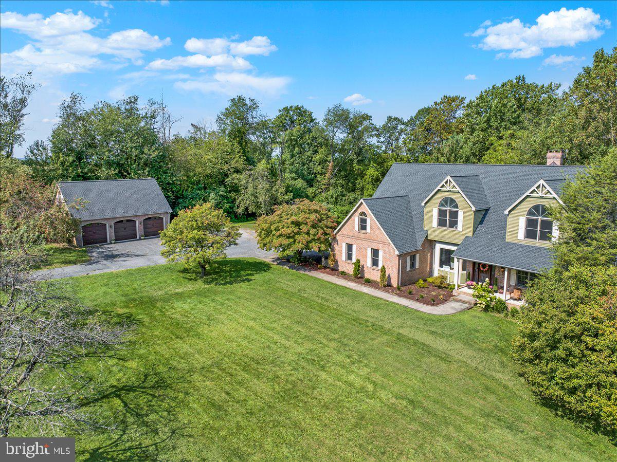Beautifully maintained 5-bedroom, 3.5-bath home situated on 11.82 private acres in the hills outside of Reading. This spacious property offers the perfect combination of privacy and accessibility and is minutes away from major highways, Tower Health and a wide variety of restaurants, yet far enough to enjoy serenity and space.
Step inside the grand entrance foyer and be drawn into the soaring family room: cathedral ceilings, a stunning floor to ceiling stone fireplace, and expansive windows offering abundant natural light.
The eat-in kitchen includes a breakfast bar, built-in desk, wine rack, and custom storage cubbies. A bright sunroom with hot tub opens to a large deck—ideal for entertaining.
Upstairs, a balcony overlooks the family room and leads to the primary suite with private bath, plus 4 additional bedrooms. The walkout lower level includes a sunken sitting area with brick fireplace, full bar, and full bath.
The outdoor setting is truly special, featuring mature apple and pear trees along the fenced pasture, a welcoming front porch, an expansive rear deck, detached 3-car garage, and barn. Whether you envision horses, a hobby farm, or simply enjoying the orchard and wide-open skies, this property offers endless possibilities.