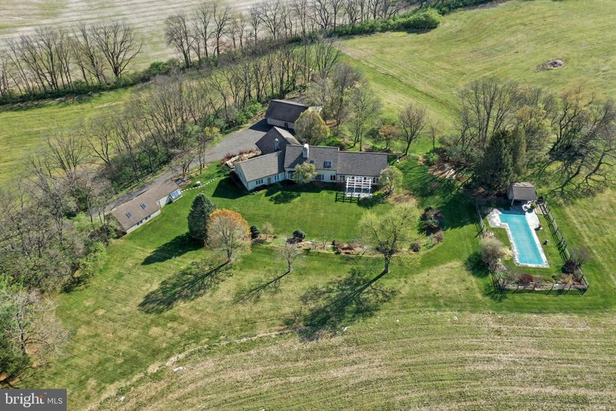 Set on an extraordinary 62 acres in the heart of the highly sought-after Wilson School District, this once-in-a-lifetime property offers a rare blend of privacy, space, and scenic beauty. With breathtaking views in every direction, this expansive estate provides the perfect backdrop for both peaceful living and unforgettable entertaining. The impressive residence boasts over 4,900 square feet of living space, featuring 4 spacious bedrooms including a owner’s suite on the first floor, 2 full bathrooms, and 1 half bath. Designed with both comfort and functionality in mind, the home offers generous living areas filled with natural light and timeless charm.  Outside, the amenities are just as remarkable. A detached 3-car garage with a dedicated workshop provides ample space for vehicles, hobbies, or storage. The in-ground pool invites you to relax and unwind during warm summer months, while the separate art studio offers a quiet, inspiring retreat for creativity or work-from-home flexibility. Whether you’re looking for a private sanctuary, a place to pursue your passions, or an opportunity to own a truly unique piece of land, this exceptional property delivers it all and yet is only minutes to shopping, restaurants and ammenities.