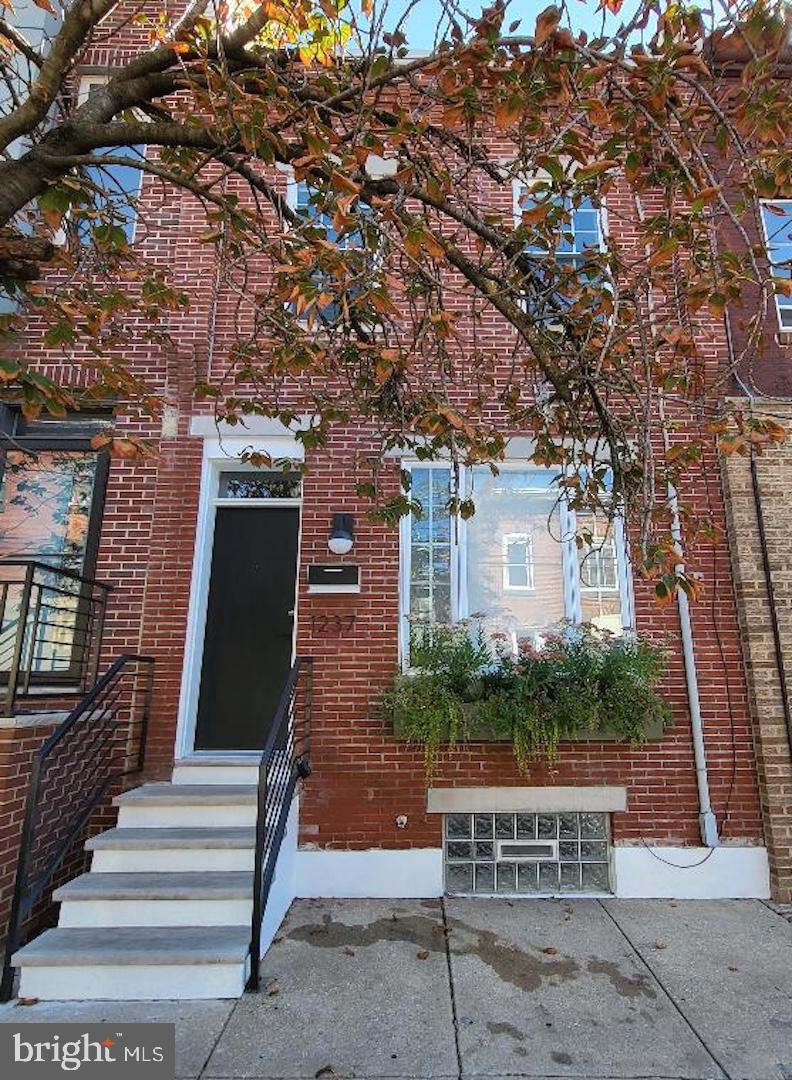 Moment of Zen! Welcome to 1237 S. 27th Street. An amazing home that combines both comfort and elegance. This meticulously updated townhouse offers 3 well-appointed bedrooms, 1.5-baths with innovative heated mirrors, luxury tile & fixtures. As you enter the home, the living room, dining room & kitchen boasts a contemporary open floor plan with keyless entry, exposed brick detail, stairway inlet wood & iron railings, moldings, upgraded recessed lighting, central air with NEST thermostat, hardwood floors and an abundance of natural light.
The galley style kitchen has been recently expanded to accommodate a growing home with new stainless steel appliances, (Refrigerator, Stove, Microwave, Dishwasher), 44" wall-to-wall cabinets, granite countertops and energy efficient windows throughout. The fully finished basement with attached laundry room offers additional living and work space when so desired. Looking for even more recreational space? This home also offers a private roof deck, plus separate organic rock garden for seasonal entertainment and personal relaxation.
Centrally located in the heart of Grays Ferry, this home resides just footsteps away from Washington Avenue, Naval Square & Point Breeze section of Philadelphia, shopping, dining, ALDI, CHASE Bank, breweries, parks & public transportation, (SEPTA).
