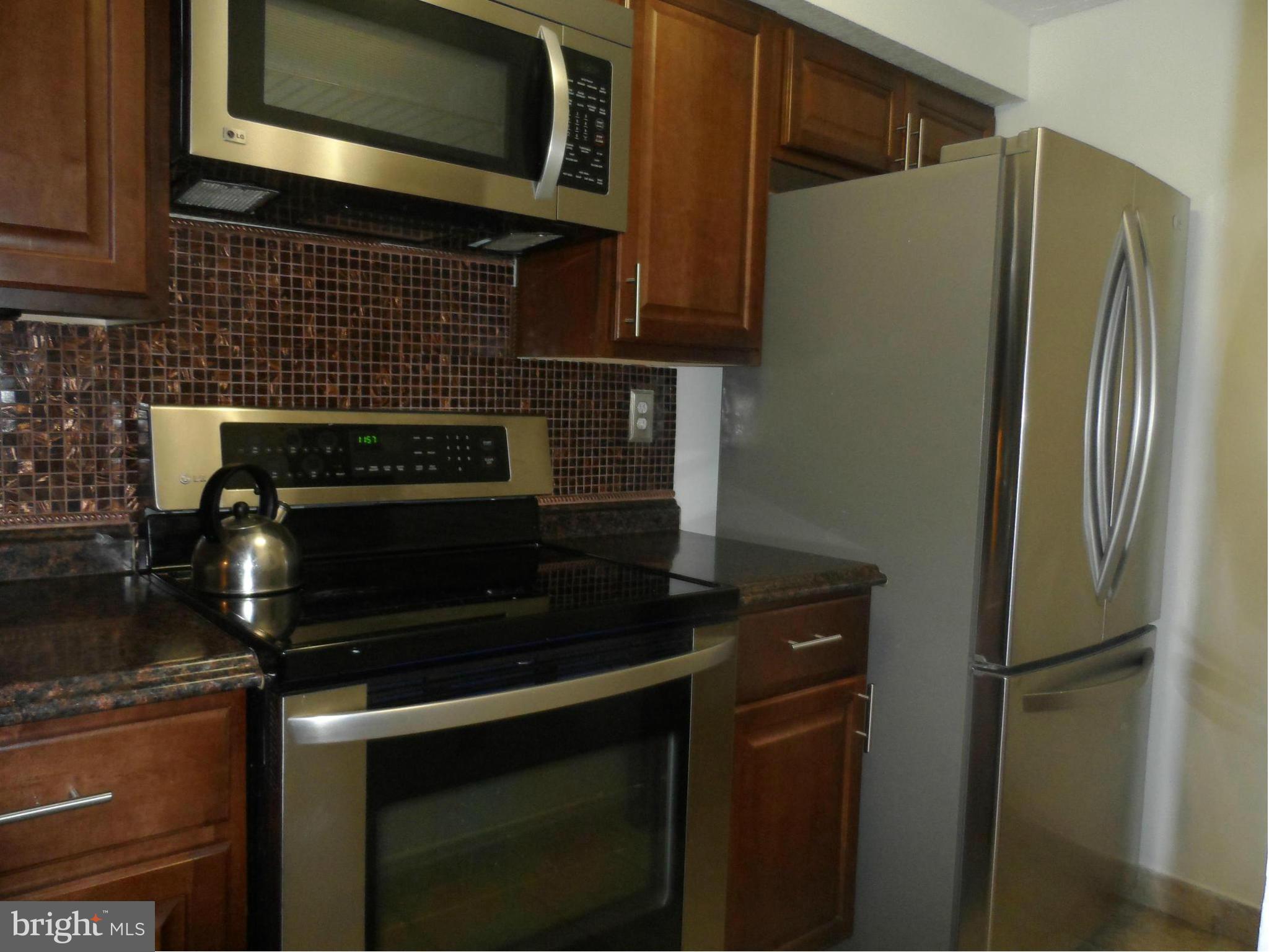 Middle level... only a few steps into unit... balcony overlooks the front of the complex. Living/ dining with hwd floors and FP. large screen TV conveys. Upgraded kitchen with ss appliances and granite.. lots of cabinets and storage. Full size w/d in unit. 2 good size bedrooms. Master with walk-in closet and attached full bath.