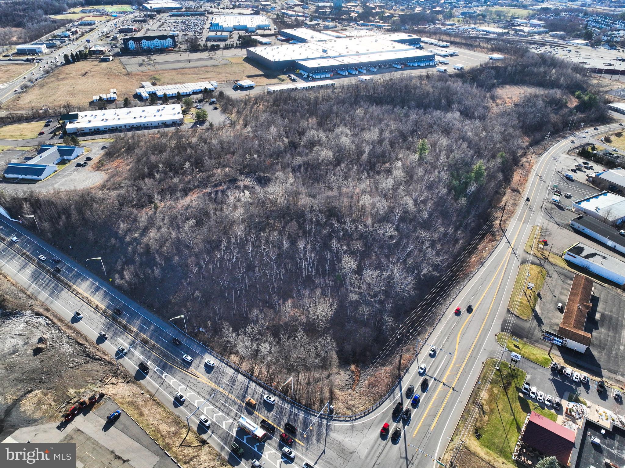 "A large Prime Commercial Corner Parcel for this Central Business District", situated along the vibrant Mundy Street/ Higland Blvd retail corridor, this property presents an exceptional development opportunity. Directly across from the Wyoming Valley Mall, The Allied Services Medical Arts Center, and Mohegan Sun Arena, it benefits from a remarkable daily traffic count of over 38,800 vehicles, ensuring high visibility and accessibility.
This property offers a diverse array of potential uses, including but not limited to: Self Storage Facilities, Gas Stations, Large Apartment Complexes, Hotel Development, Grocery Outlets, Trucking Terminals, Professional Medical Offices, Large Scale Car Dealerships. With 736,164 square feet of buildable area, the property can accommodate whatever you are planning in your next business venture! Centrally located between Route 309 and Interstate 81, makes it easily accessible for local and out of state customers. The New York & Philadelphia Metro areas can be reached via Interstate-81 in 1 hour and 45-minutes, which is merely 110 miles away.
Therefore, this "Large Undeveloped Prime Commercial Corner Land Parcel," is ripe for development! Potential buyers are encouraged to explore the various tax incentive programs available.