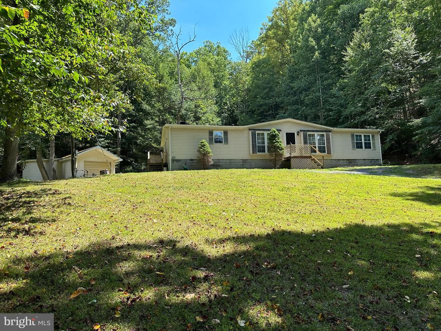 PRIVACY WITH CONVENIENCE.....15 UNRESTRICTED ACRES FRONTING ON RT 50 WITH SPACIOUS DOUBLEWIDE & GARAGE/WORKSHOP. PHENOMENALLY GORGEOUS LAND WITH HUGE TREES, ROCK OUTCROPPINGS AND BOLD STREAM......HOME SETS BACK OFF THE ROAD FOR MAXIMUM PRIVACY, YET AN EASY 30 MINUTE COMMUTE TO WINCHESTER, VA. NEW SURVEY WITH CLEARY MARKED BOUNDARIES. HIKE, HUNT & SHOOT ON YOUR OWN LAND! FOR A 30 YEAR OLD DOUBLEWIDE, IT'S IN GOOD CONDITION AND HAS A CONCRETE PERIMETER, SHOULD QUALIFY FOR ANY TYPE OF FINANCING. NEW FURNACE, DISHWASHER & RANGE HOOD. 24X16 GARAGE WITH 10X10 LEAN TO.....PLENTY OF STORAGE FOR YOUR BIG BOY TOYS. THE INTERIOR OF THE HOME IS ALL ORIGINAL AND COULD USE A MORE MODERN FACELIFT, OTHERWISE IT'S GOOD TO GO. I DARE YOU TO FIND A BETTER DEAL IN THIS MARKET! A LOT OF BANG FOR YOUR BUCK, SLEEP EASY AT NIGHT KNOWING YOU GOT YOUR MONIES WORTH!